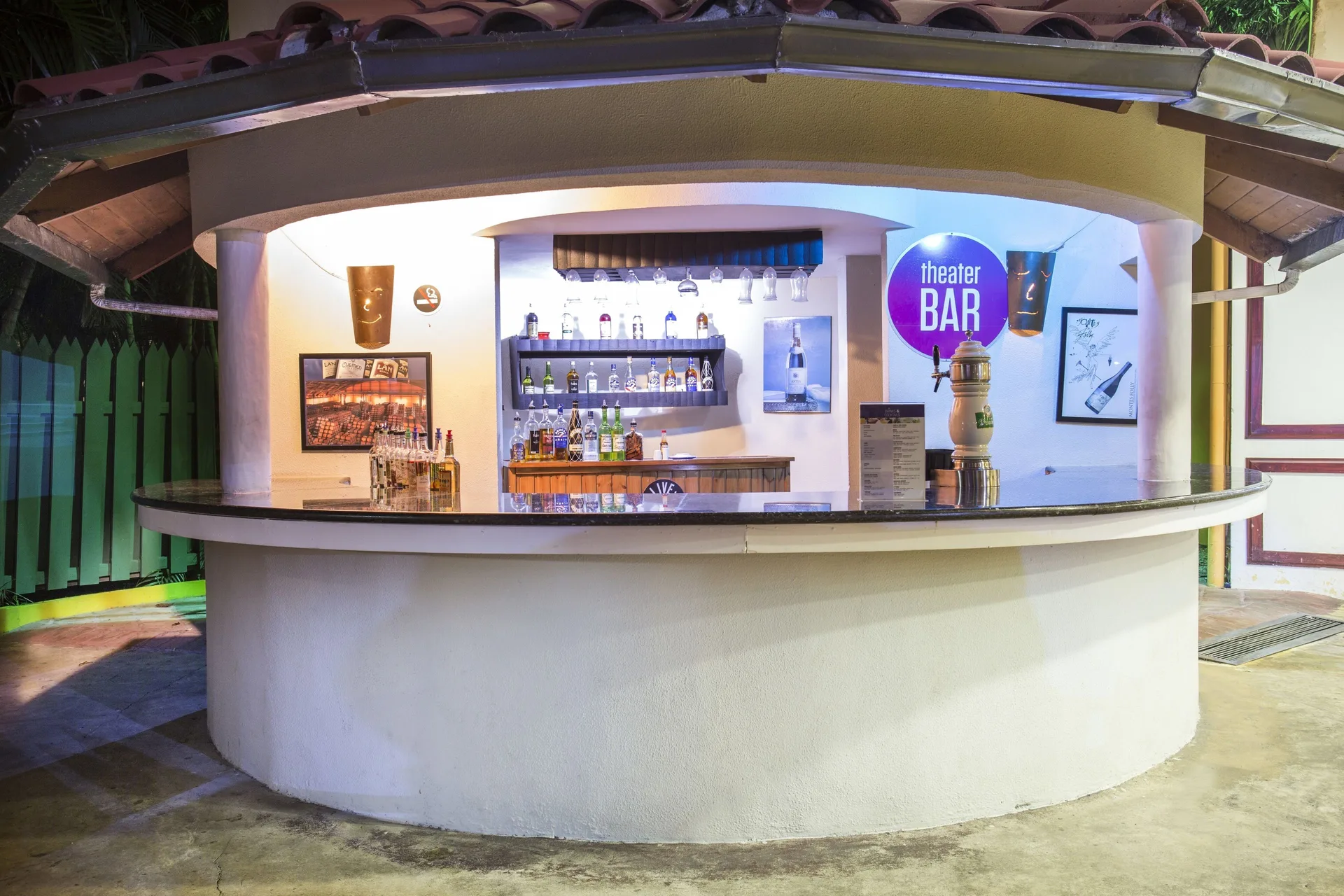Theater Bar counter with bottles and illuminated sign at Marien Puerto Plata.
