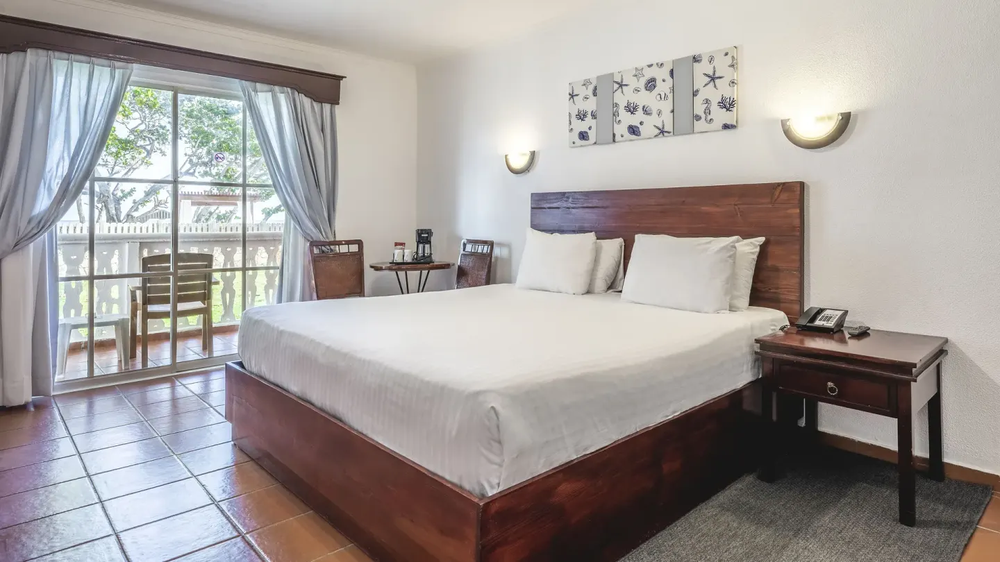 Deluxe Ocean View king room with balcony, wall art, and seating at Marien Puerto Plata.