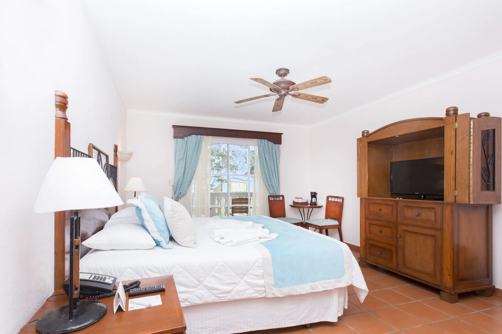 Deluxe Ocean View room with king bed, TV cabinet, and balcony at Marien Puerto Plata.