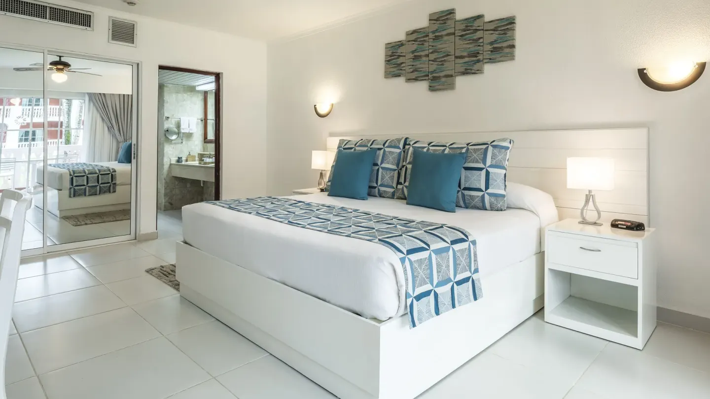 Family Room with king bed, balcony doors, and bathroom vanity at Marien Puerto Plata.