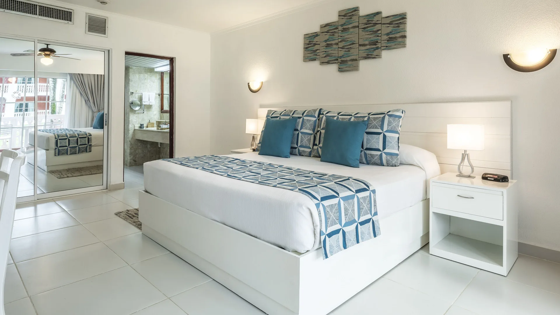 Family Room with king bed, balcony doors, and bathroom vanity at Marien Puerto Plata.