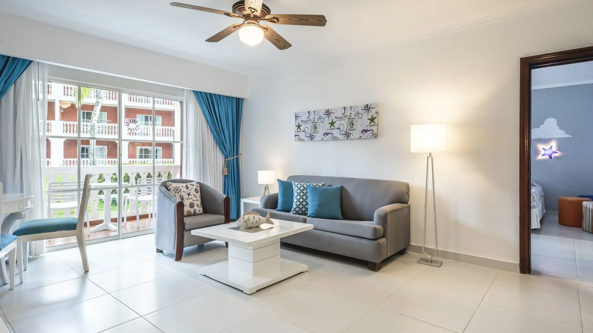 Family Room living area with sofa, balcony doors, and view into a kids' bedroom at Marien Puerto Plata.