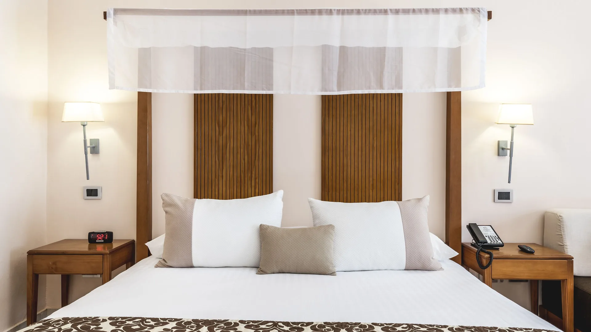Superior Room Pool View king bed with bedside tables at Marien Puerto Plata.