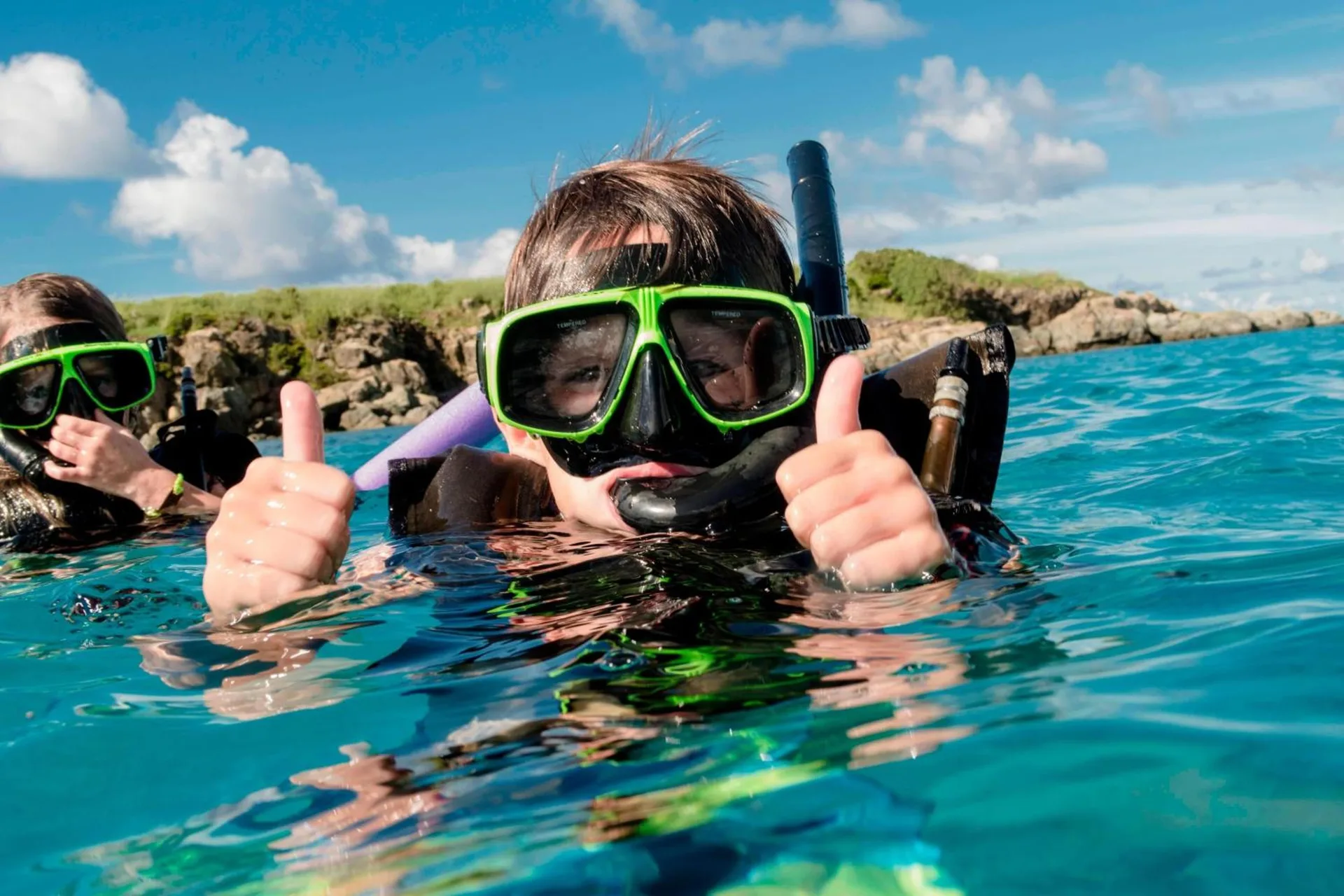 Snorkelers in clear turquoise water near Marriott's Frenchman's Cove.