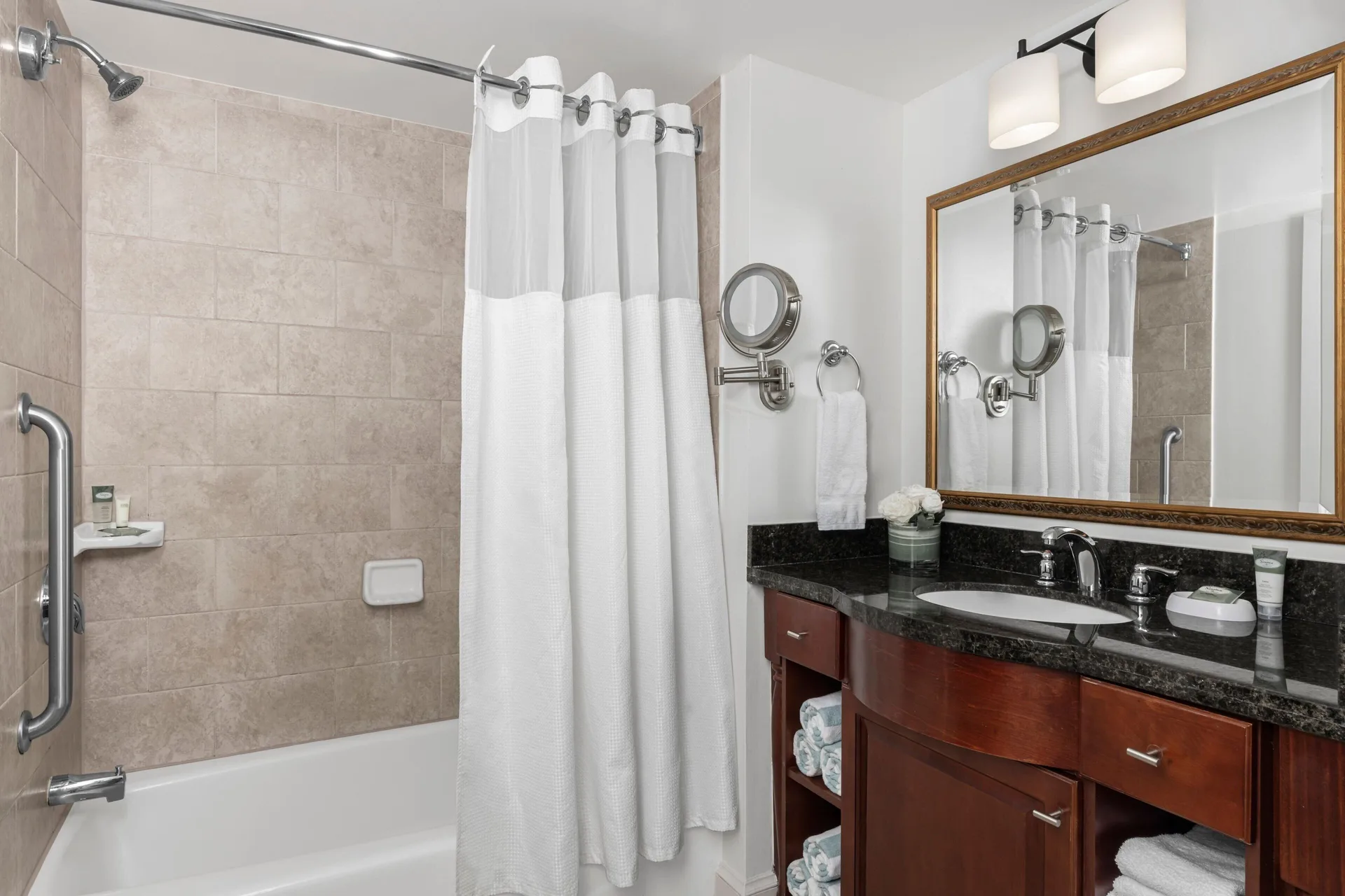 Villa bathroom with tub, shower curtain and vanity at Marriott's Frenchman's Cove.