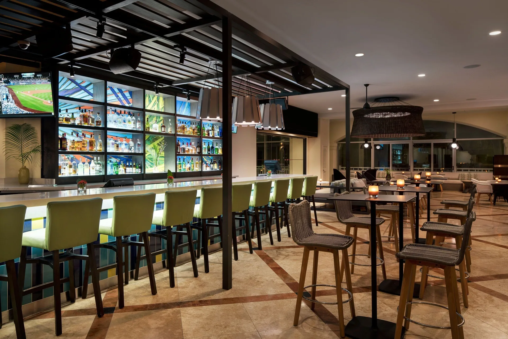 Bar with illuminated shelves and high tables at Marriott's St. Kitts Beach Club.