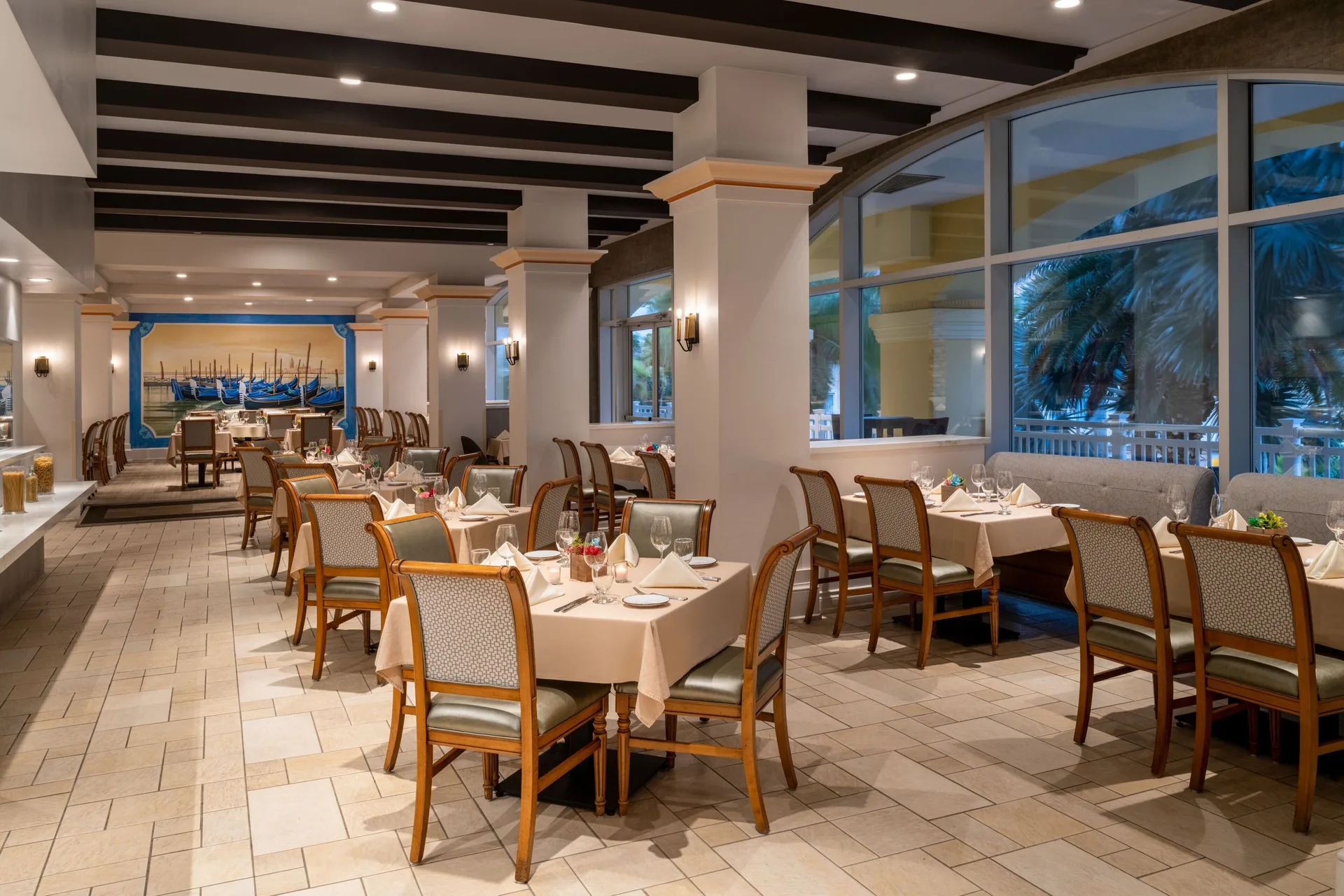 Dining room with set tables and large windows at Marriott's St. Kitts Beach Club.