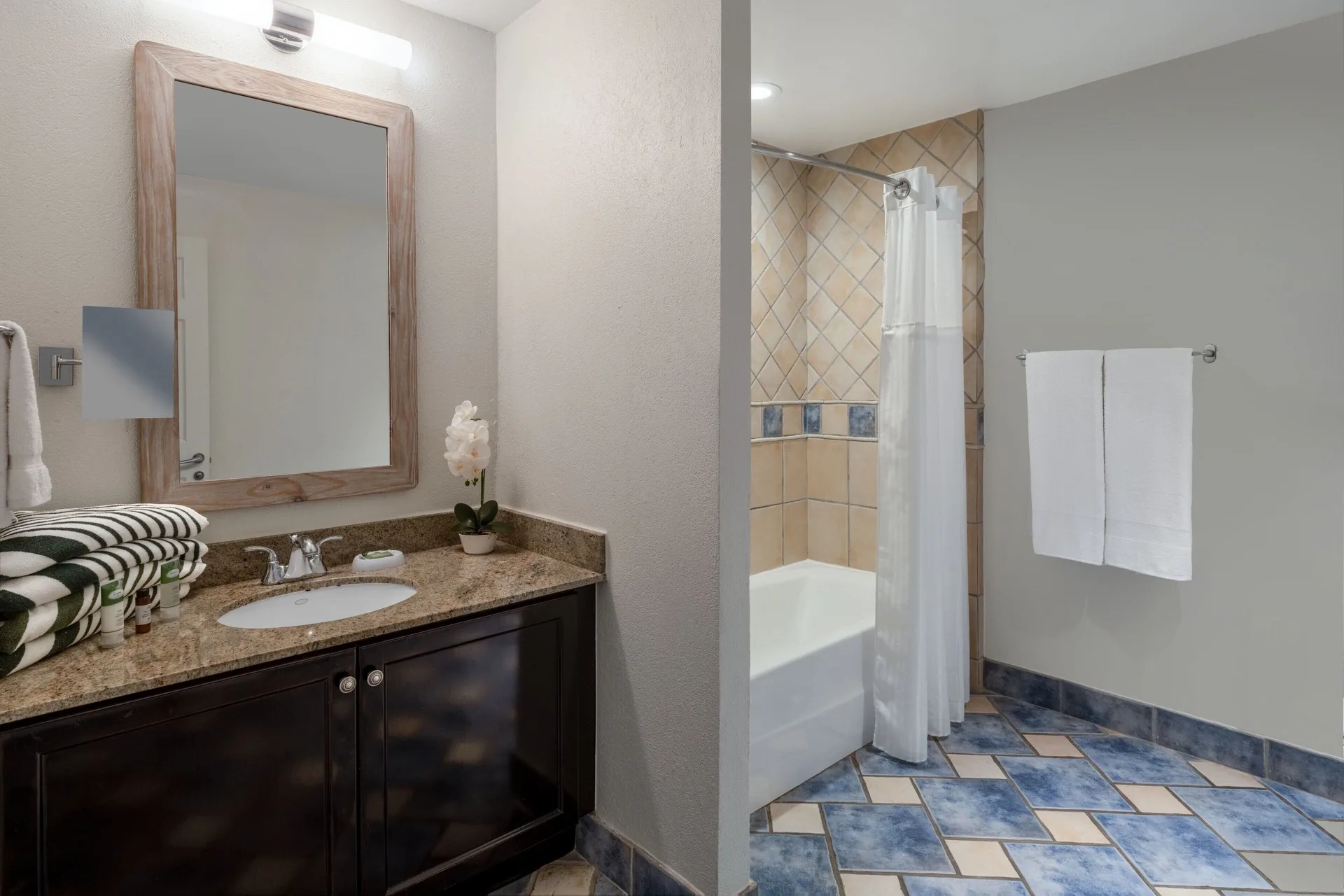 Bathroom in a three-bedroom villa at Marriott's St. Kitts Beach Club with vanity and tub-shower.