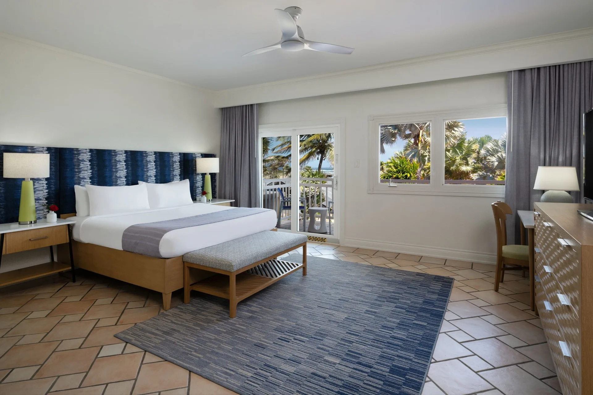 King bedroom in a three-bedroom villa at Marriott's St. Kitts Beach Club with balcony doors and seating.