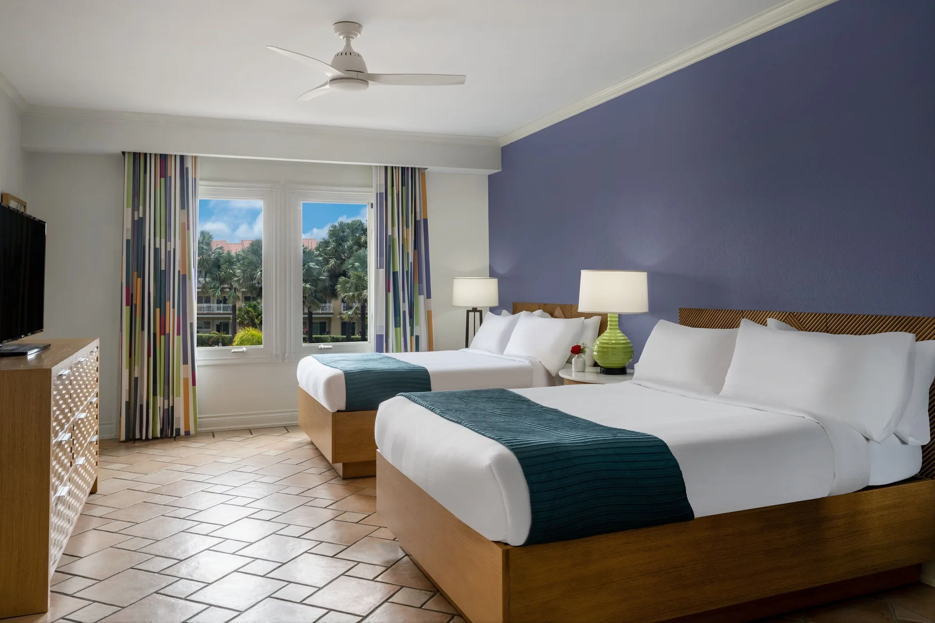 Two-bed bedroom in a three-bedroom villa at Marriott's St. Kitts Beach Club with blue accent wall.