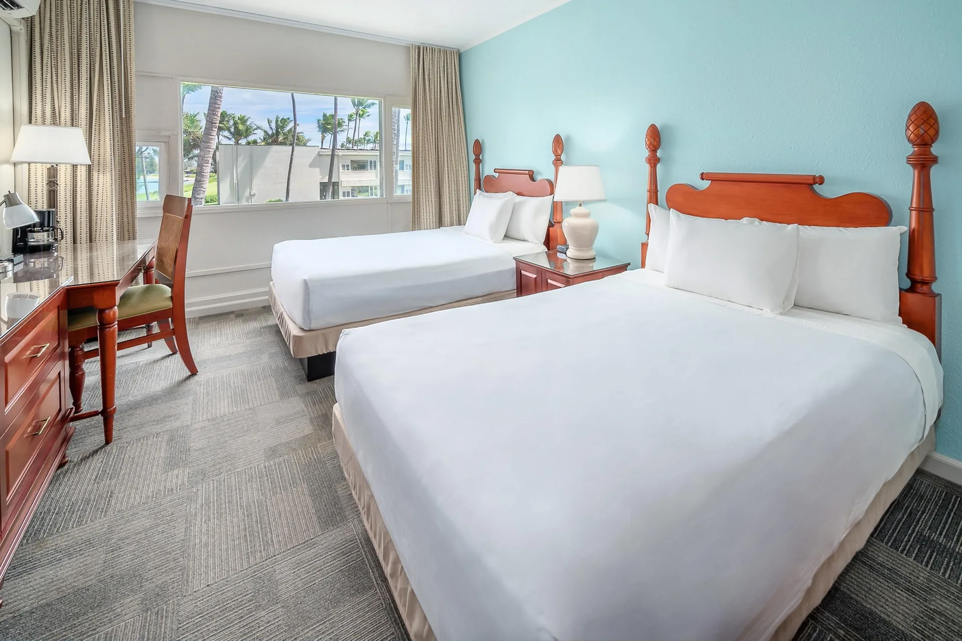 Room Ocean View with two beds, desk, and window at Maui Beach Hotel.