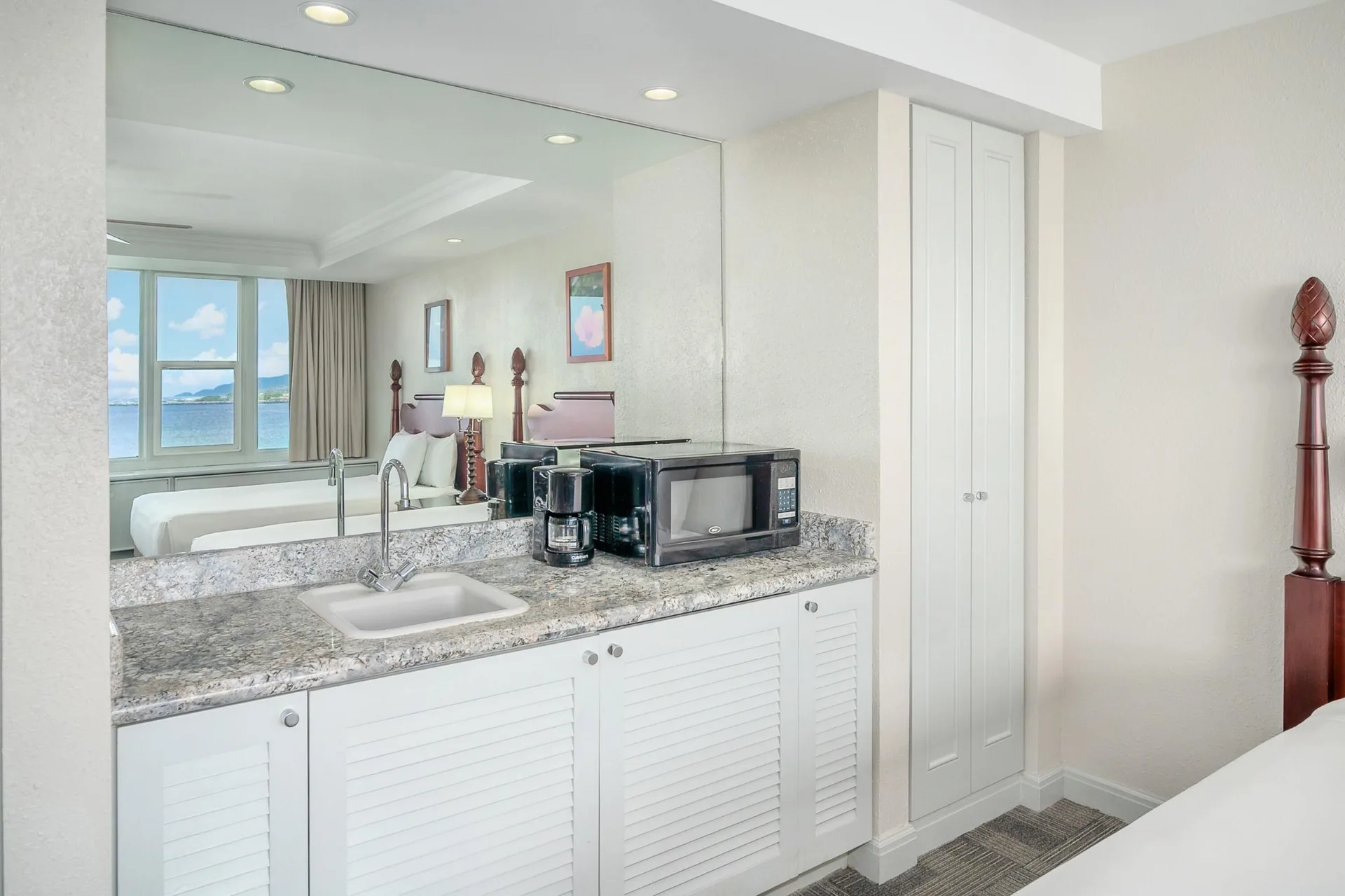 Oceanfront suite kitchenette area beside the bed at Maui Beach Hotel.