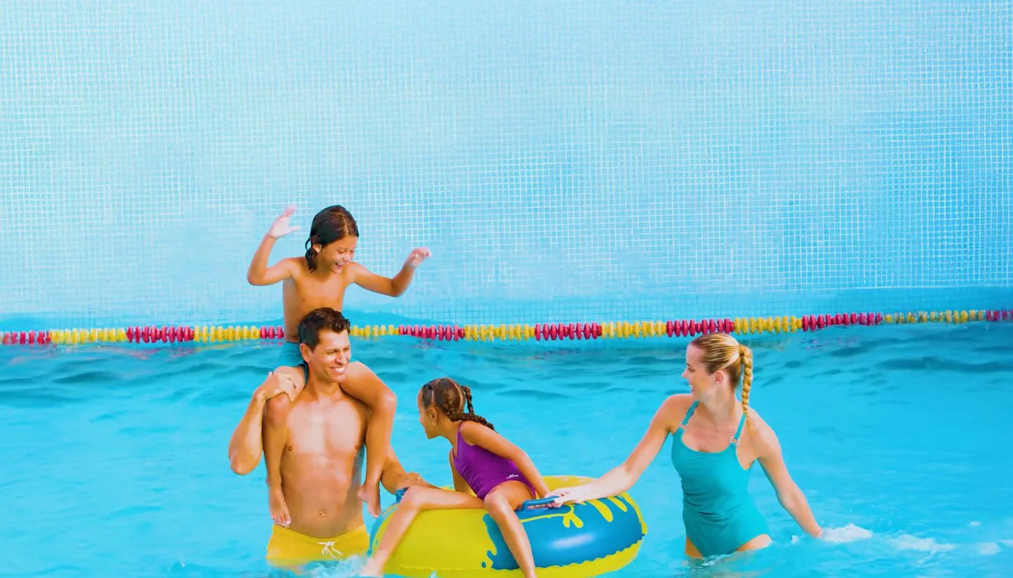 Family playing with an inflatable float in the pool at Moon Palace Jamaica.