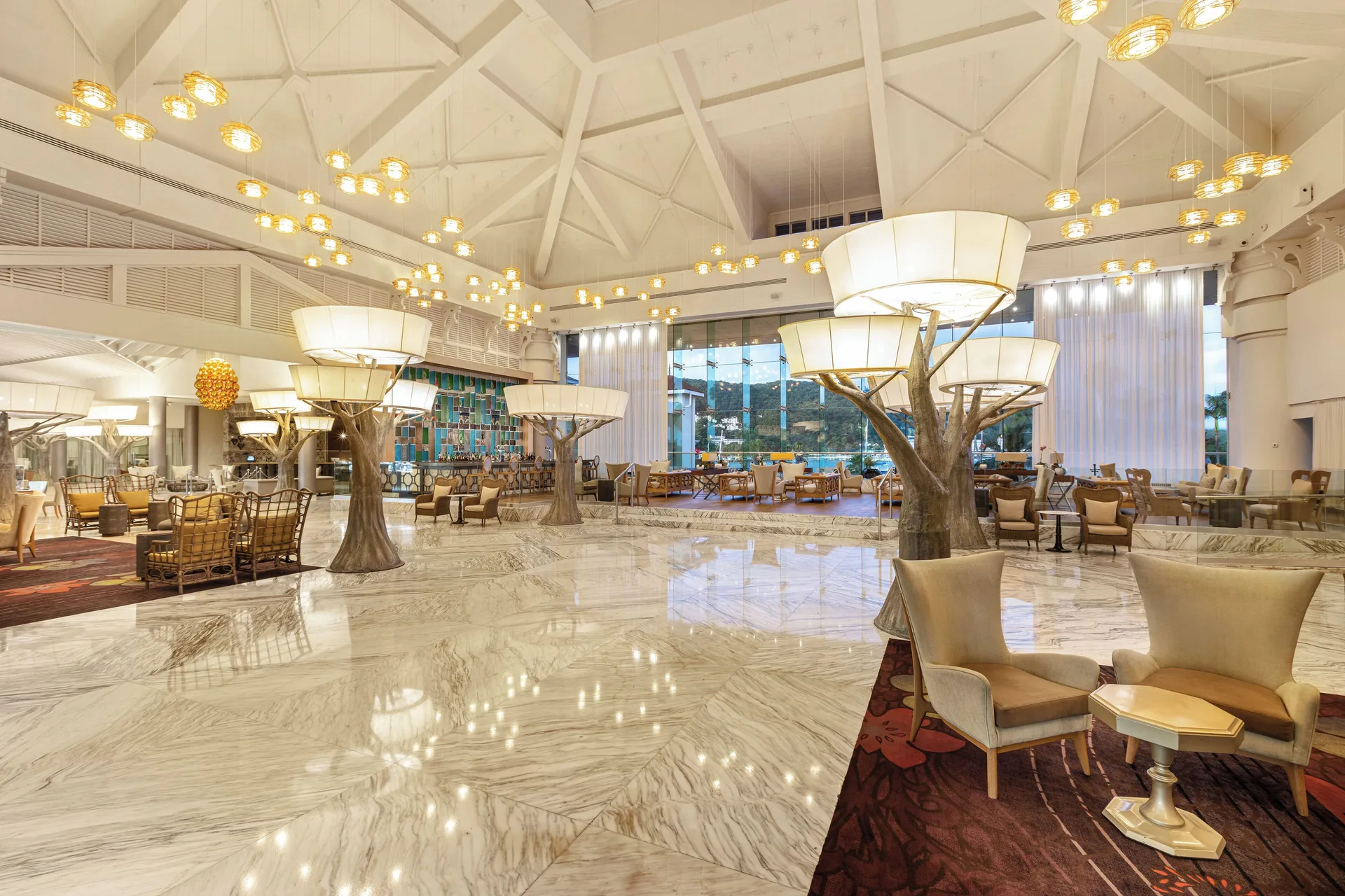 Spacious marble lobby lounge with tree-like lamps at Moon Palace Jamaica.