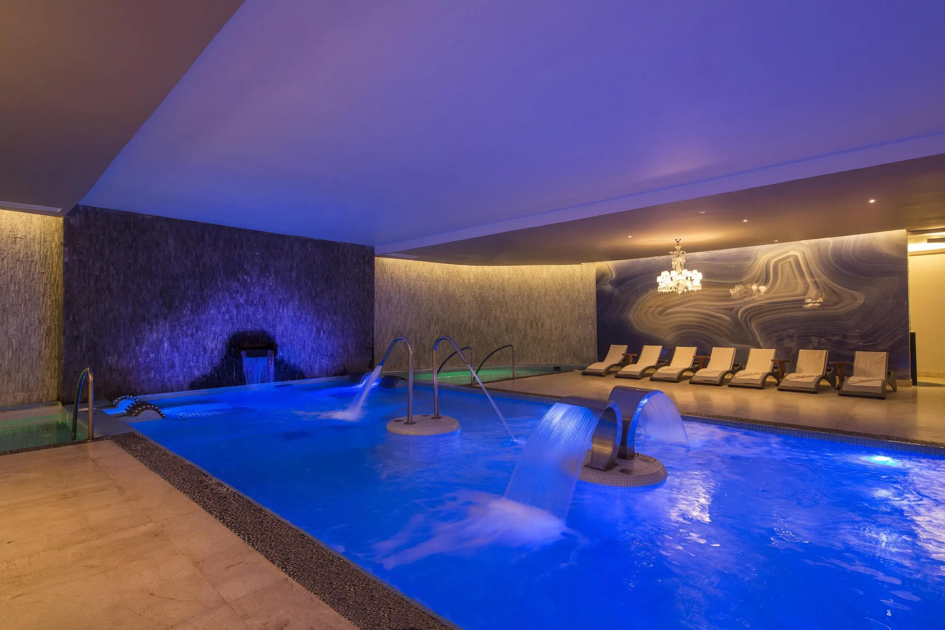 An indoor spa pool with blue lighting and water features at Moon Palace Jamaica.