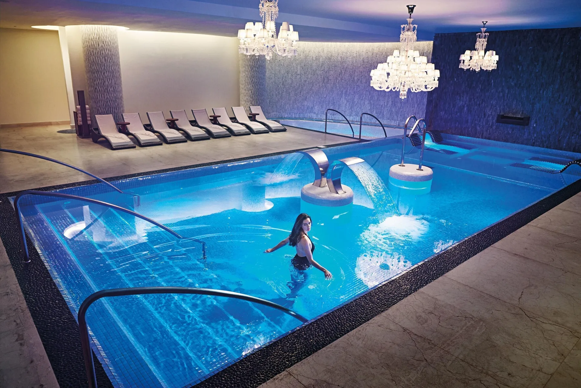 Indoor spa pool with chandeliers and water features at Moon Palace Jamaica.