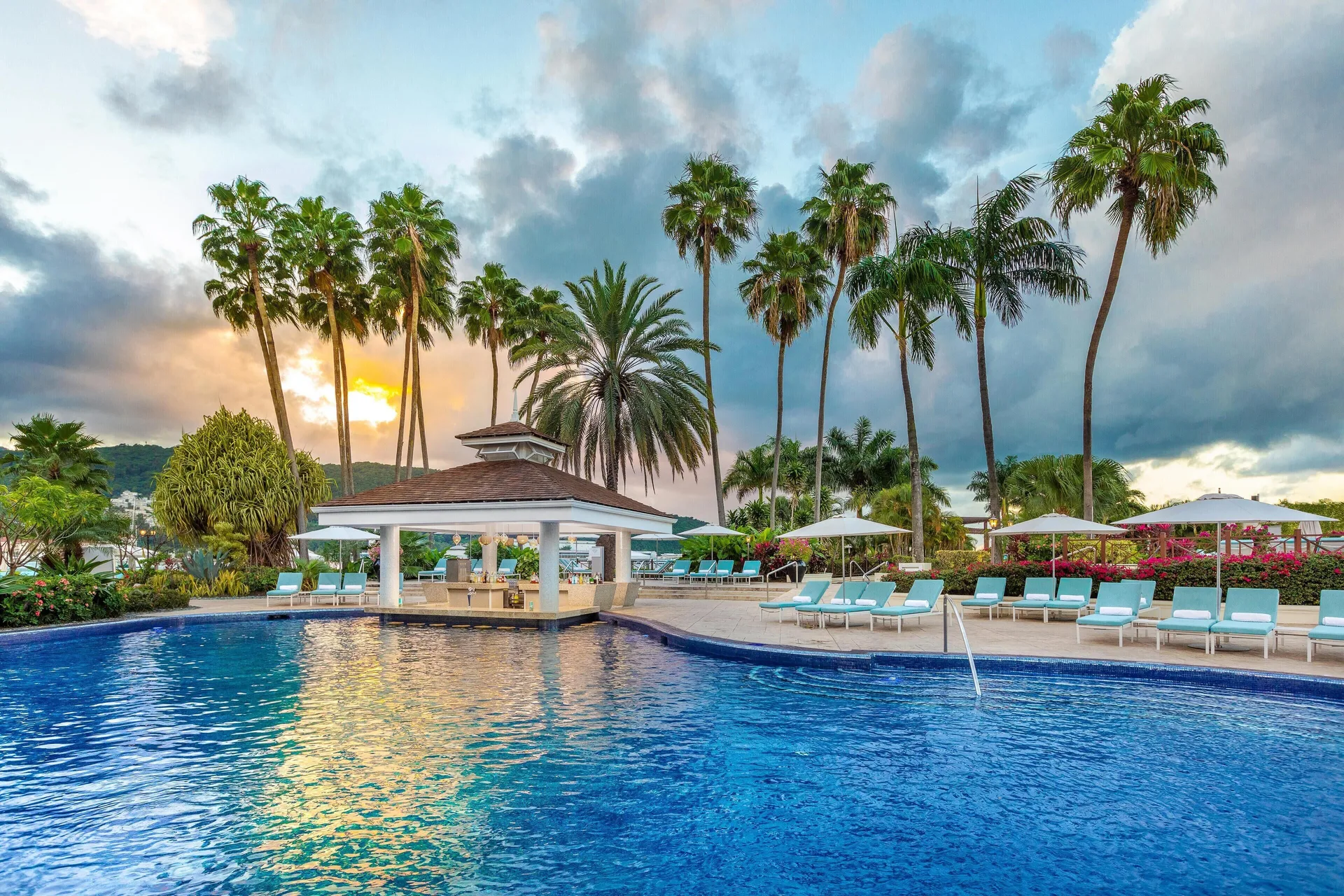 Palm-lined swimming pool and lounge deck at Moon Palace Jamaica.