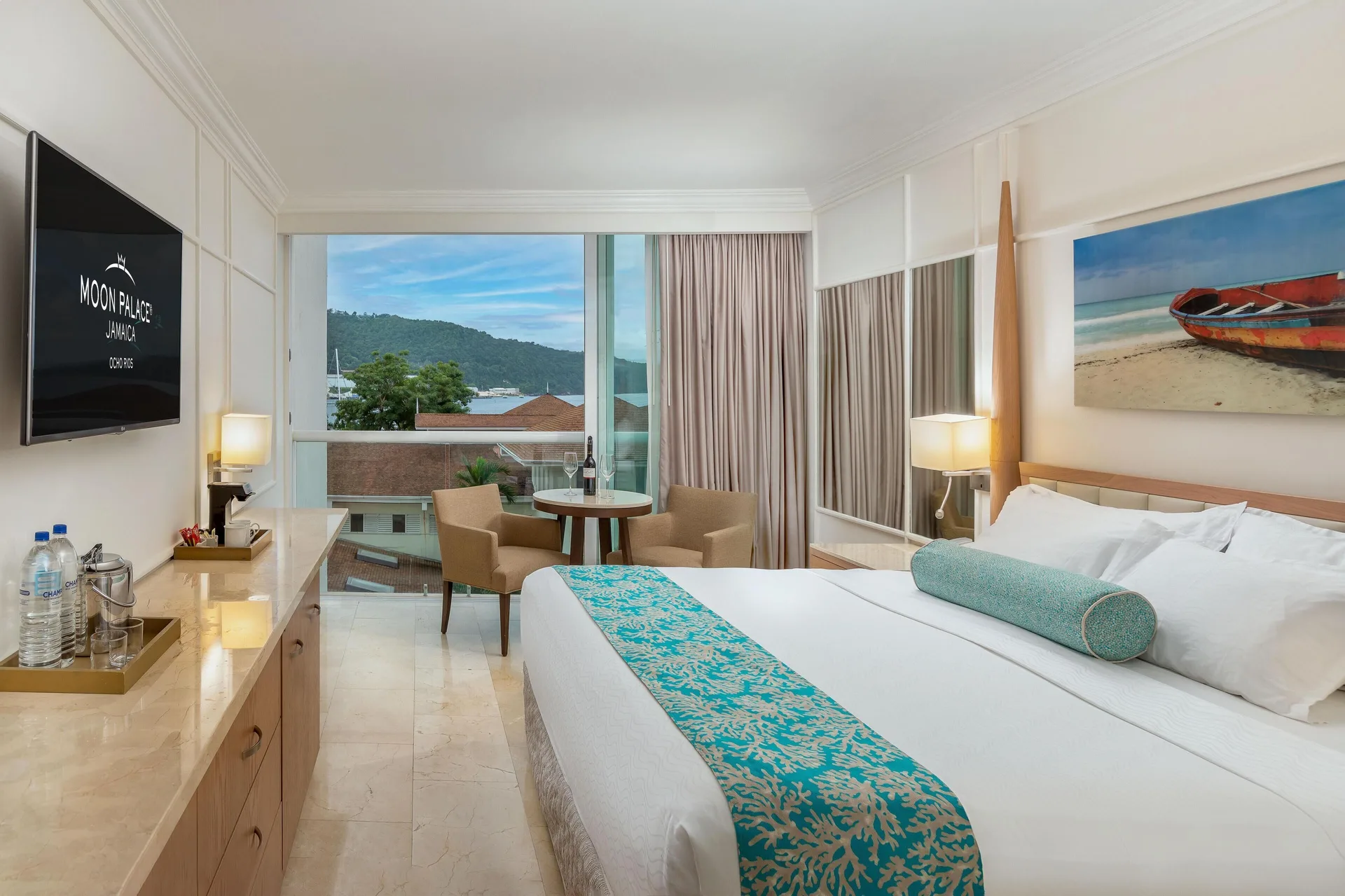 Deluxe Resort View king room with balcony and TV at Moon Palace Jamaica.