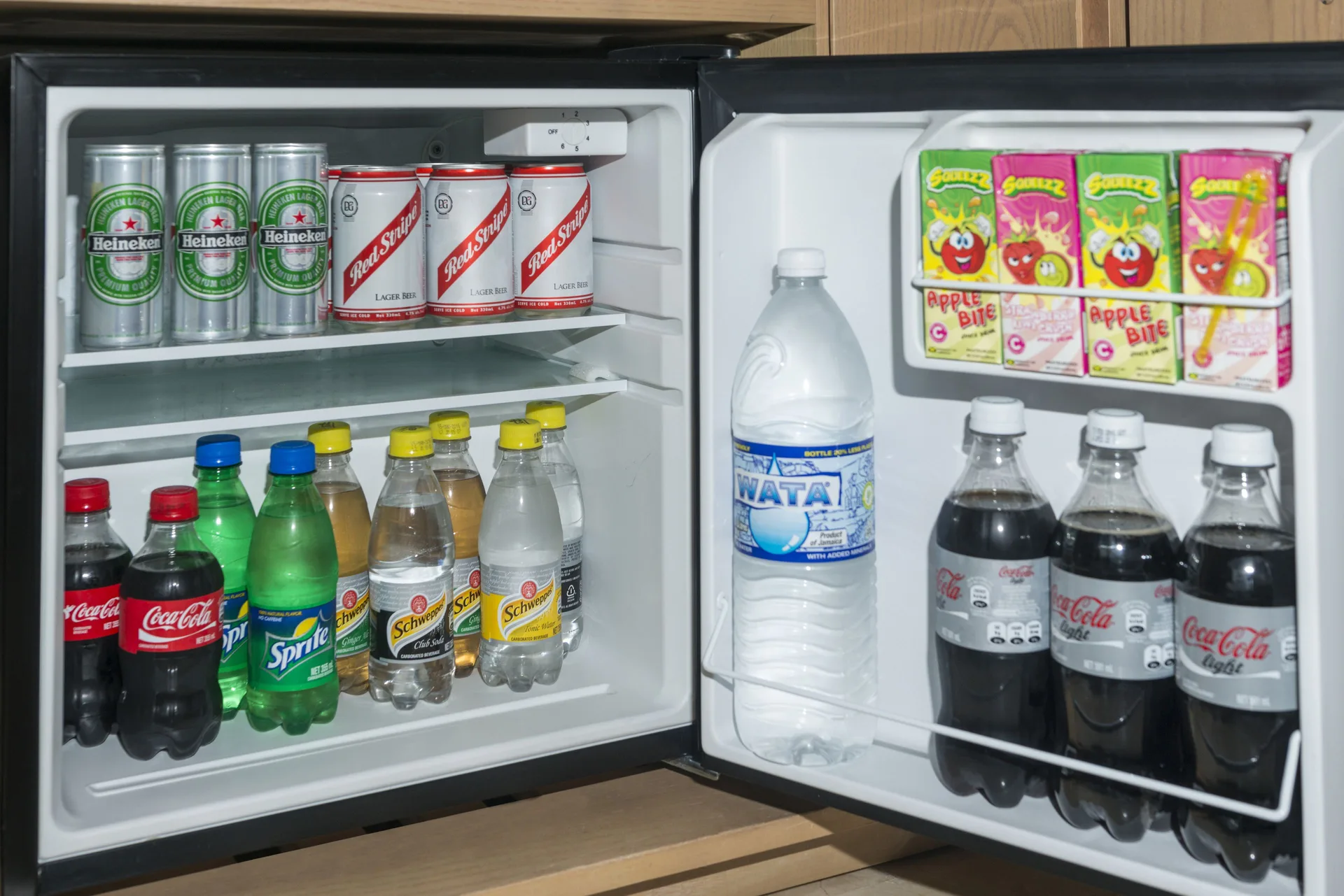 Open guest room minibar stocked with drinks at Moon Palace Jamaica.