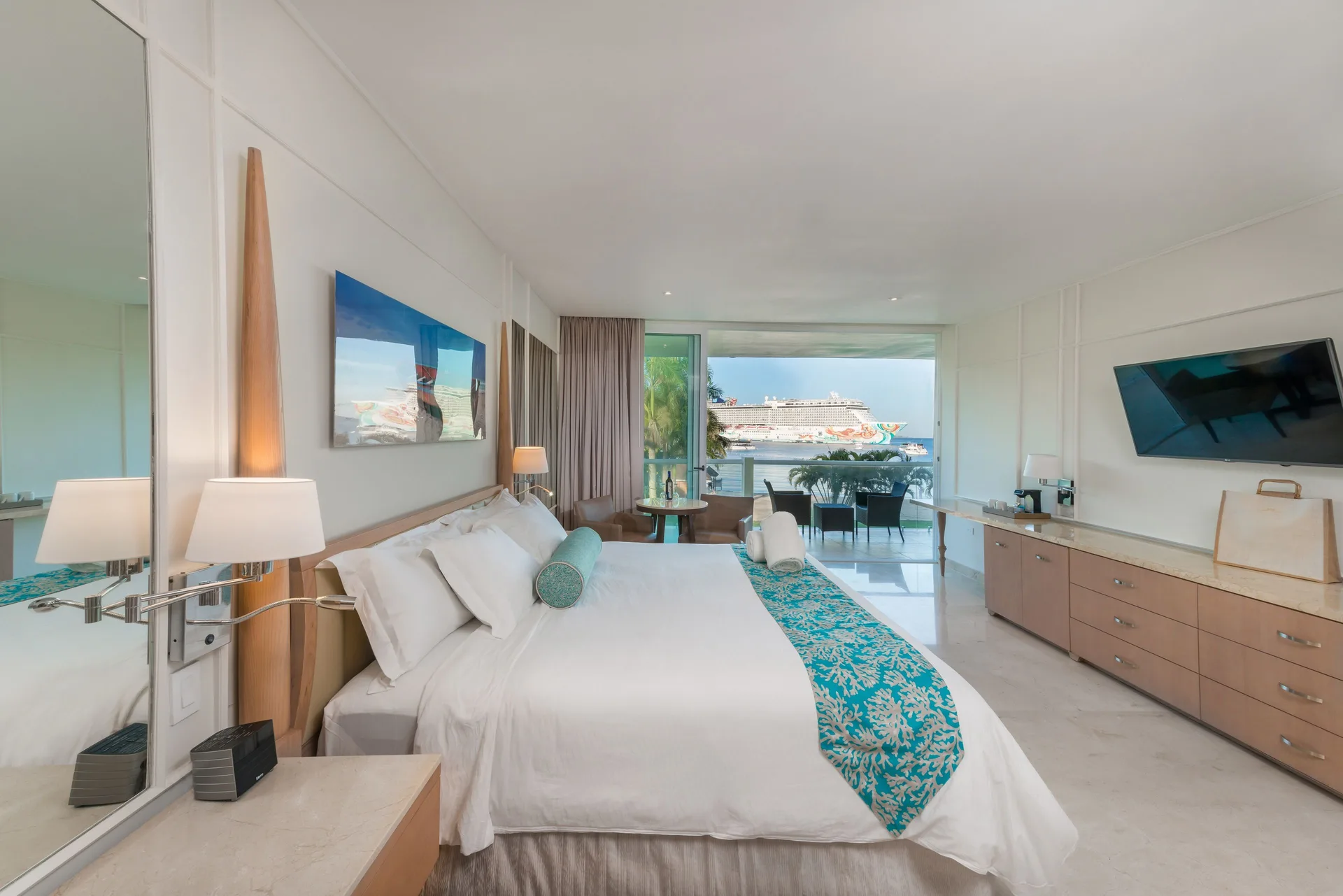 Superior Governor Suite ocean view king bedroom at Moon Palace Jamaica with balcony and TV.
