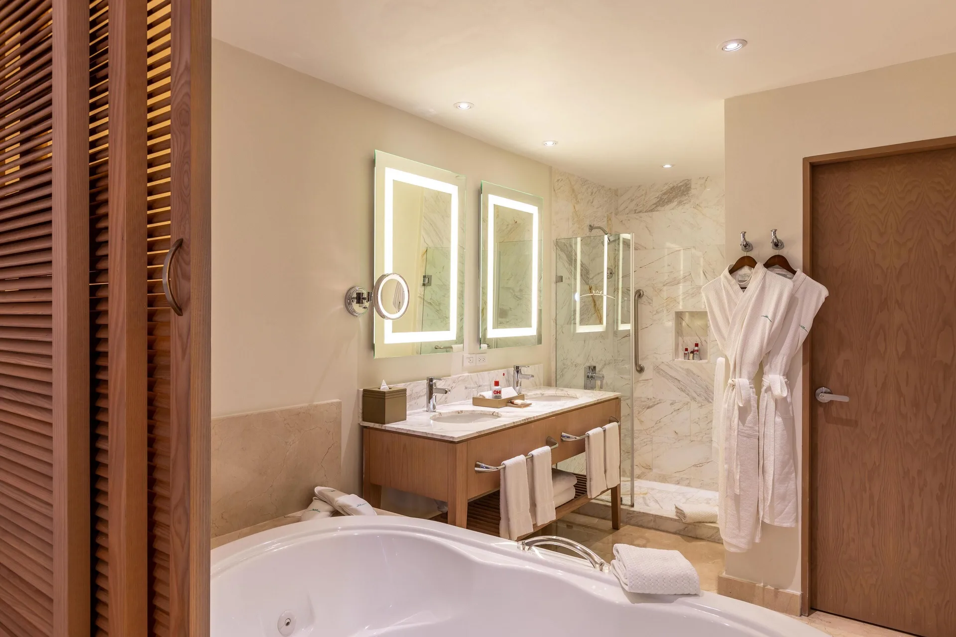 Superior Junior Suite Ocean View bathroom with tub and robes at Moon Palace Jamaica.
