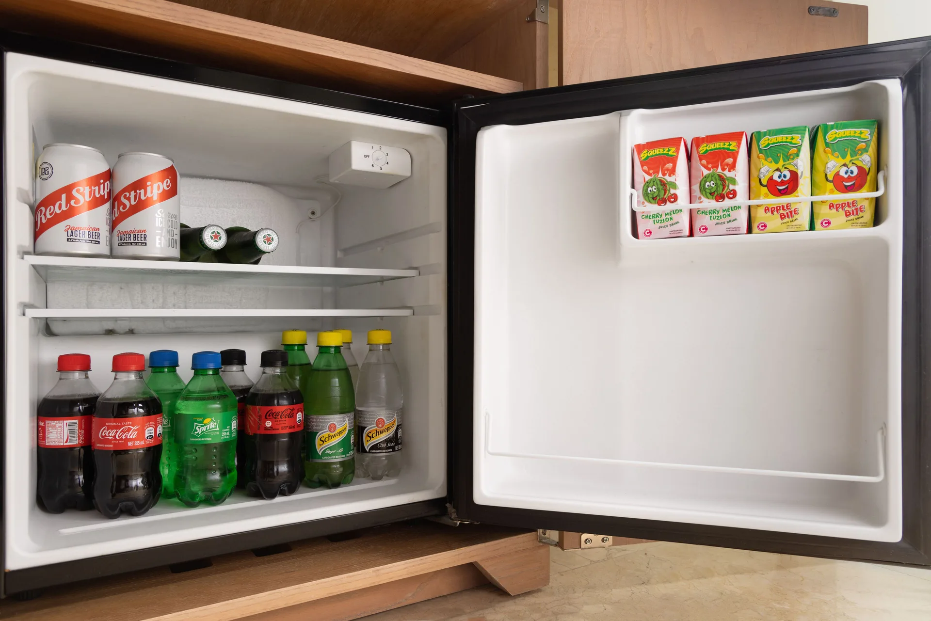 Open in-room minibar with drinks and snacks at Moon Palace Jamaica.