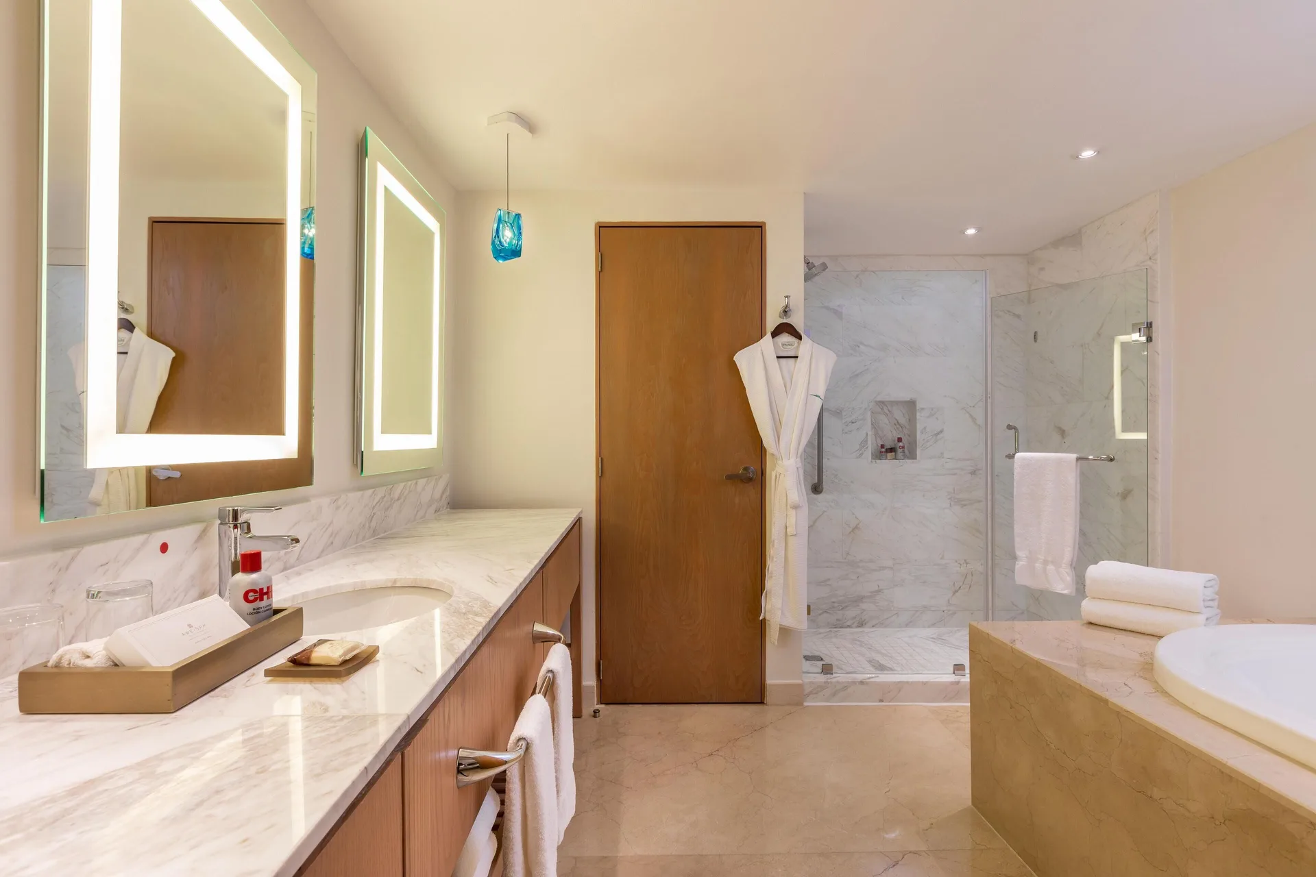 Marble bathroom with vanity, shower and soaking tub in a presidential suite at Moon Palace Jamaica.