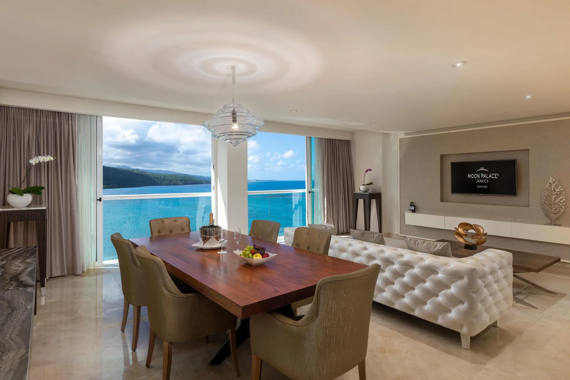 Dining and living area with ocean-view windows at Moon Palace Jamaica.