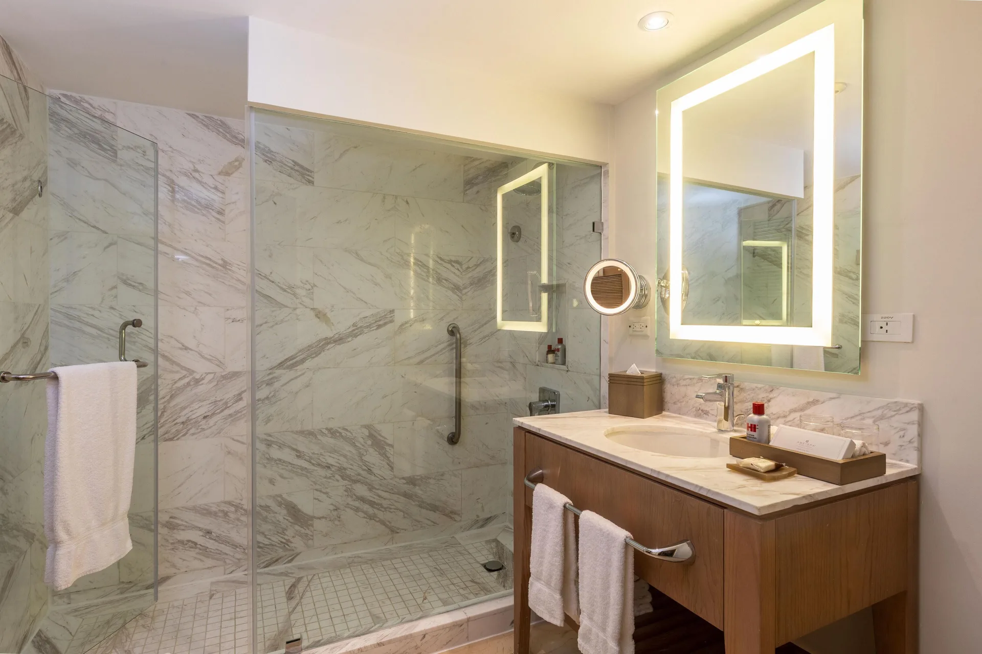 Single vanity and glass marble shower in a presidential suite bathroom at Moon Palace Jamaica.