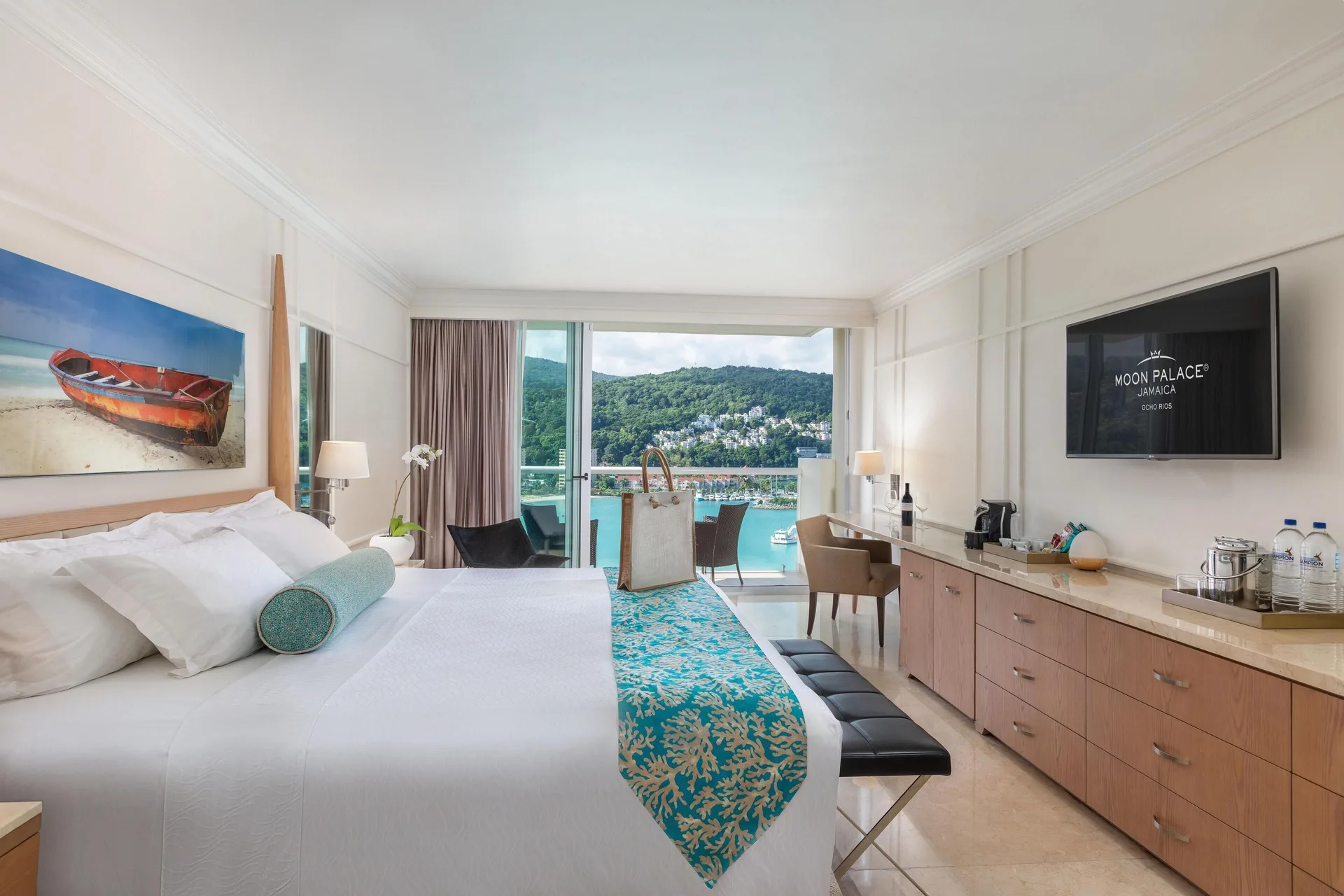 King-bed suite bedroom with balcony and bay view at Moon Palace Jamaica.