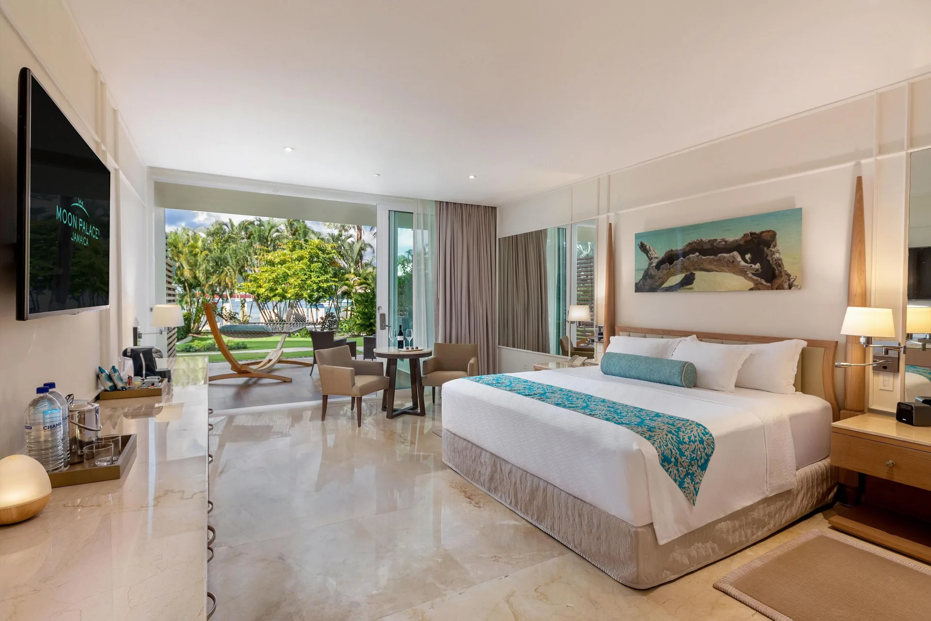 Superior Walk Out Suite Ocean View king bed and patio at Moon Palace Jamaica.