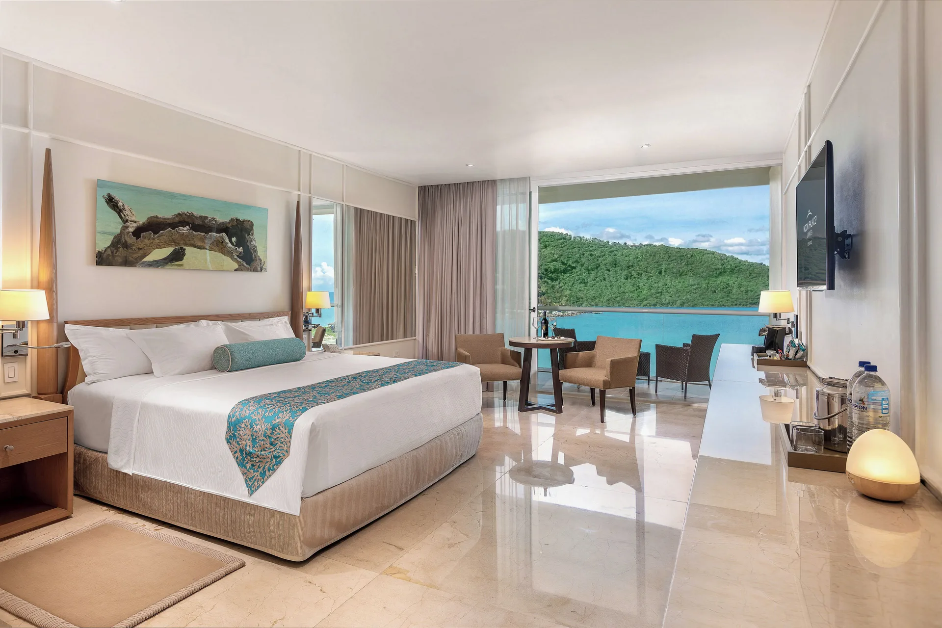 Three Bedroom Villa bedroom with king bed and balcony at Moon Palace Jamaica.