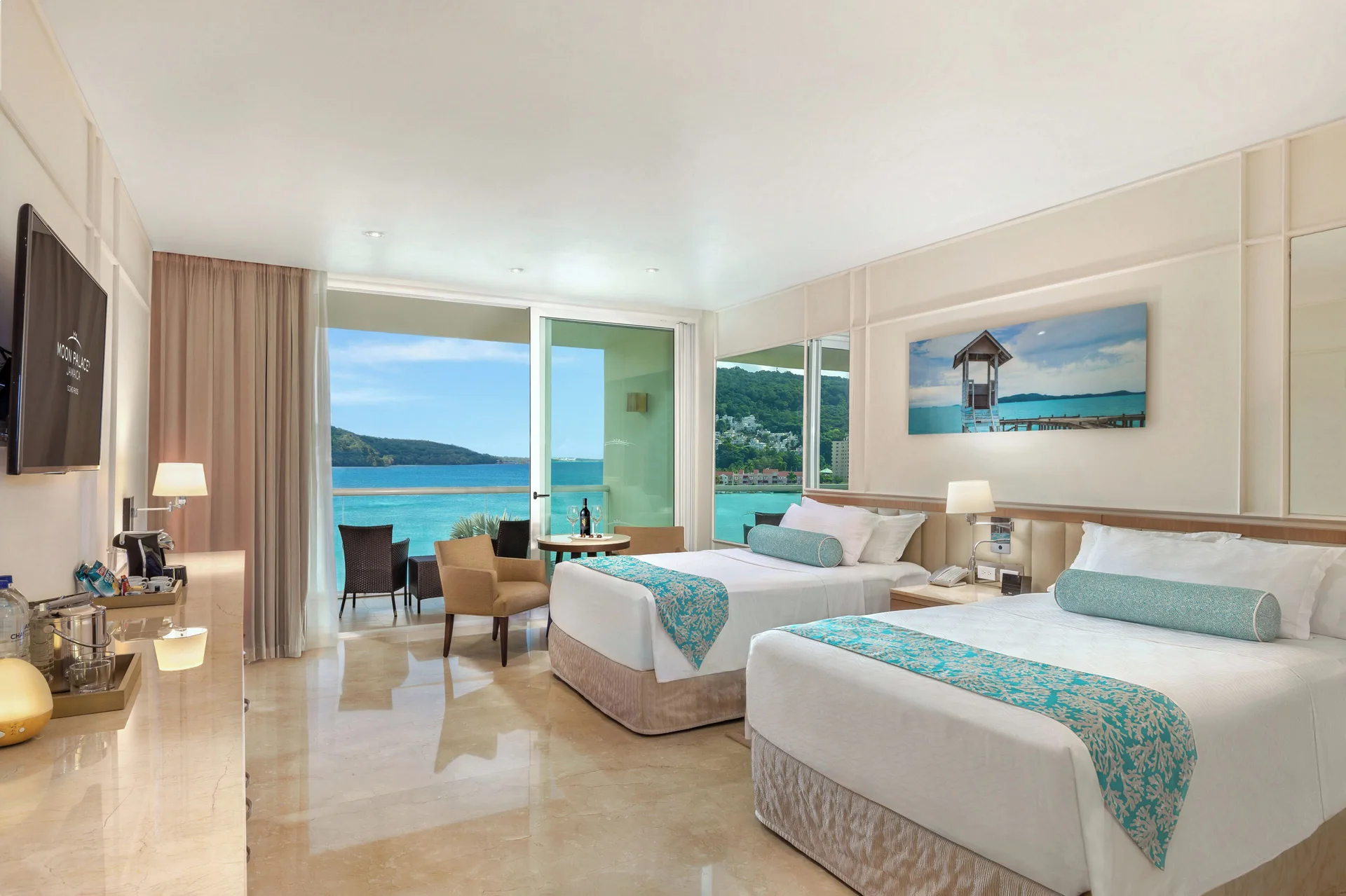 Three Bedroom Villa bedroom with two beds and ocean view at Moon Palace Jamaica.