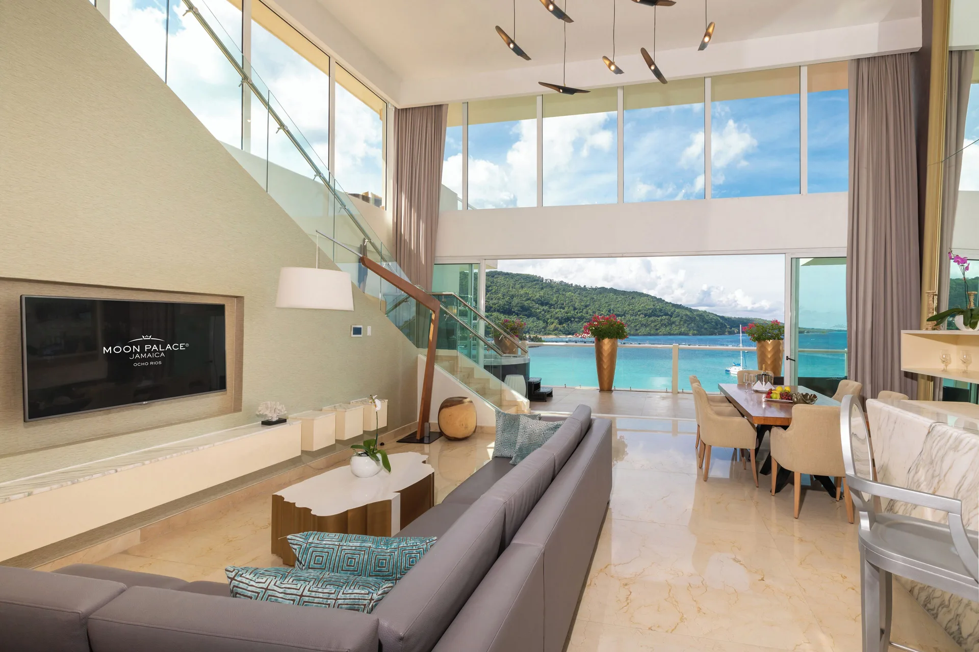 Three Bedroom Villa living room with staircase and sea view at Moon Palace Jamaica.