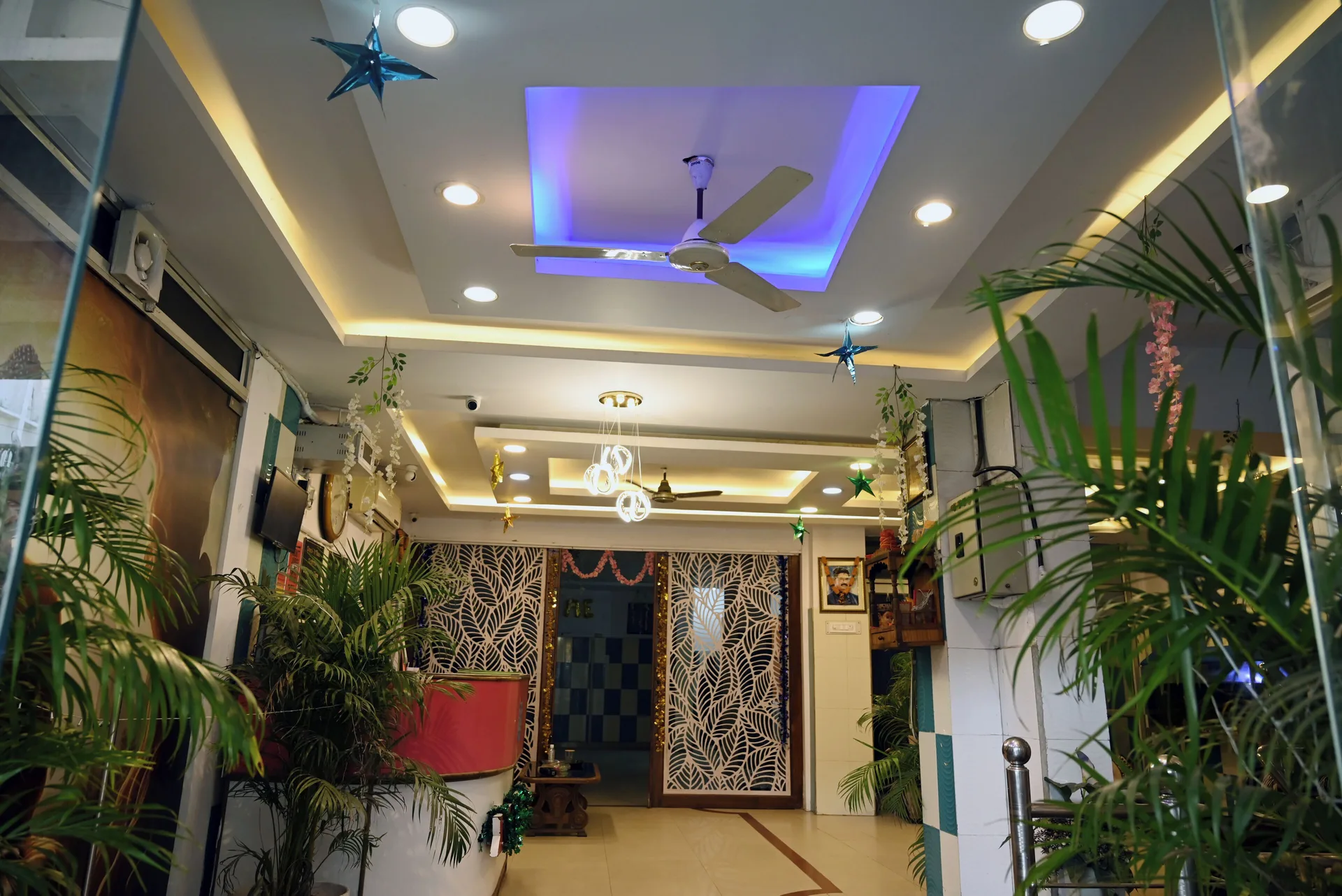 The Moon Palace lobby entrance area with plants, ceiling lights, and hanging star decorations.