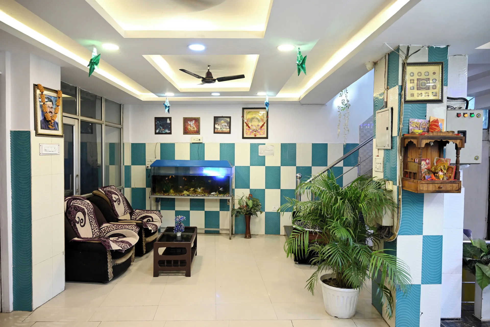 A Moon Palace lobby lounge with armchairs, an aquarium, potted plants, and tiled walls.