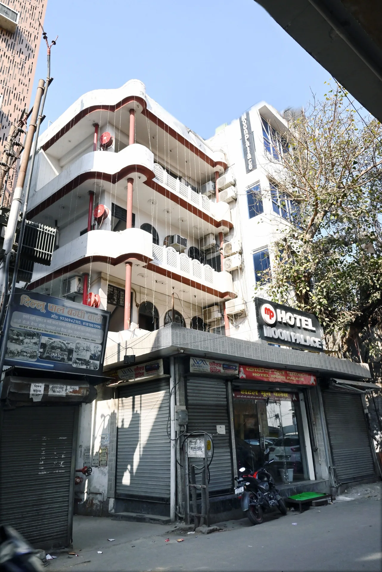 The exterior of Moon Palace with balconies above a street-level hotel entrance.