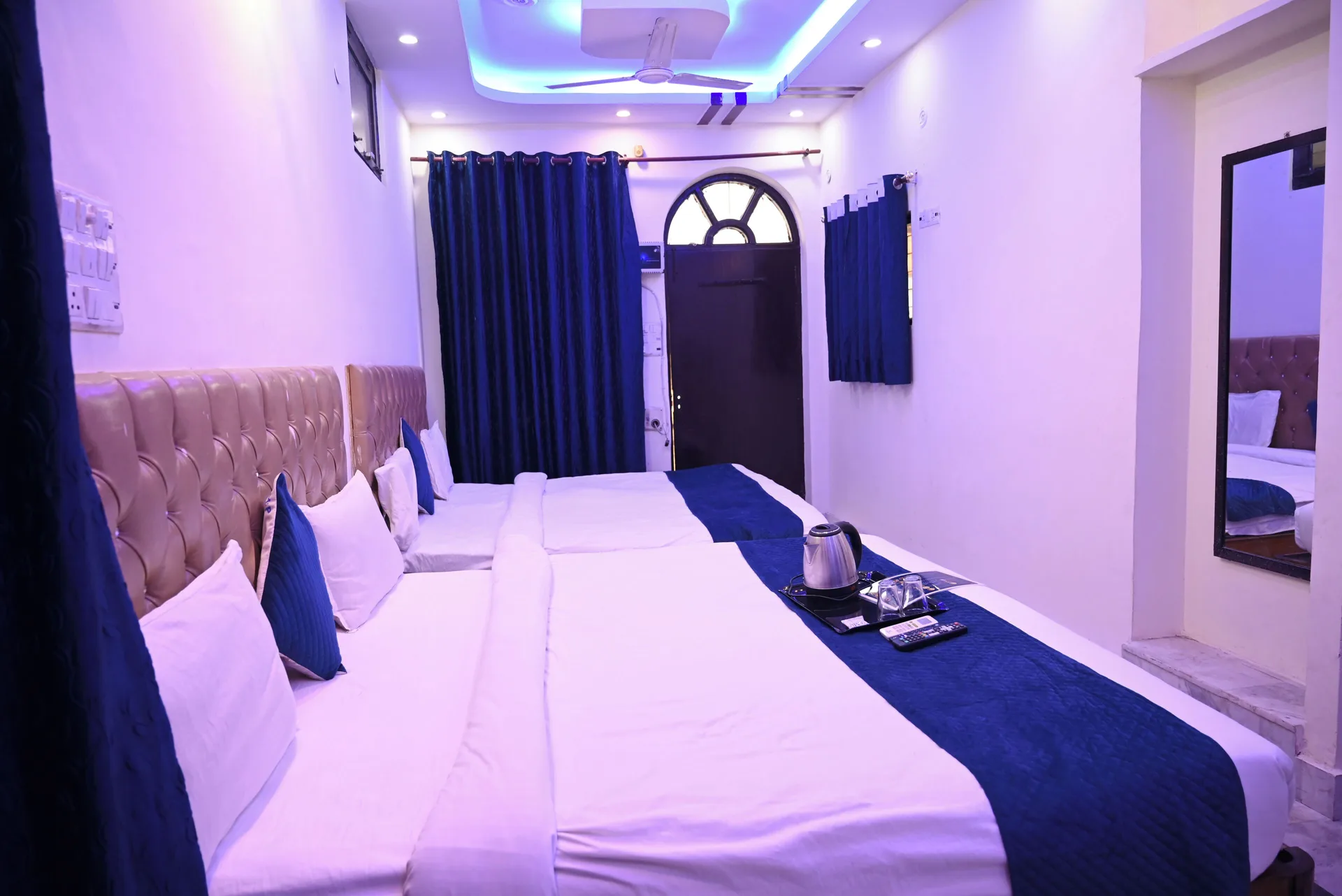 Classic Room with twin beds, blue accents, mirror, and tea tray at Moon Palace.