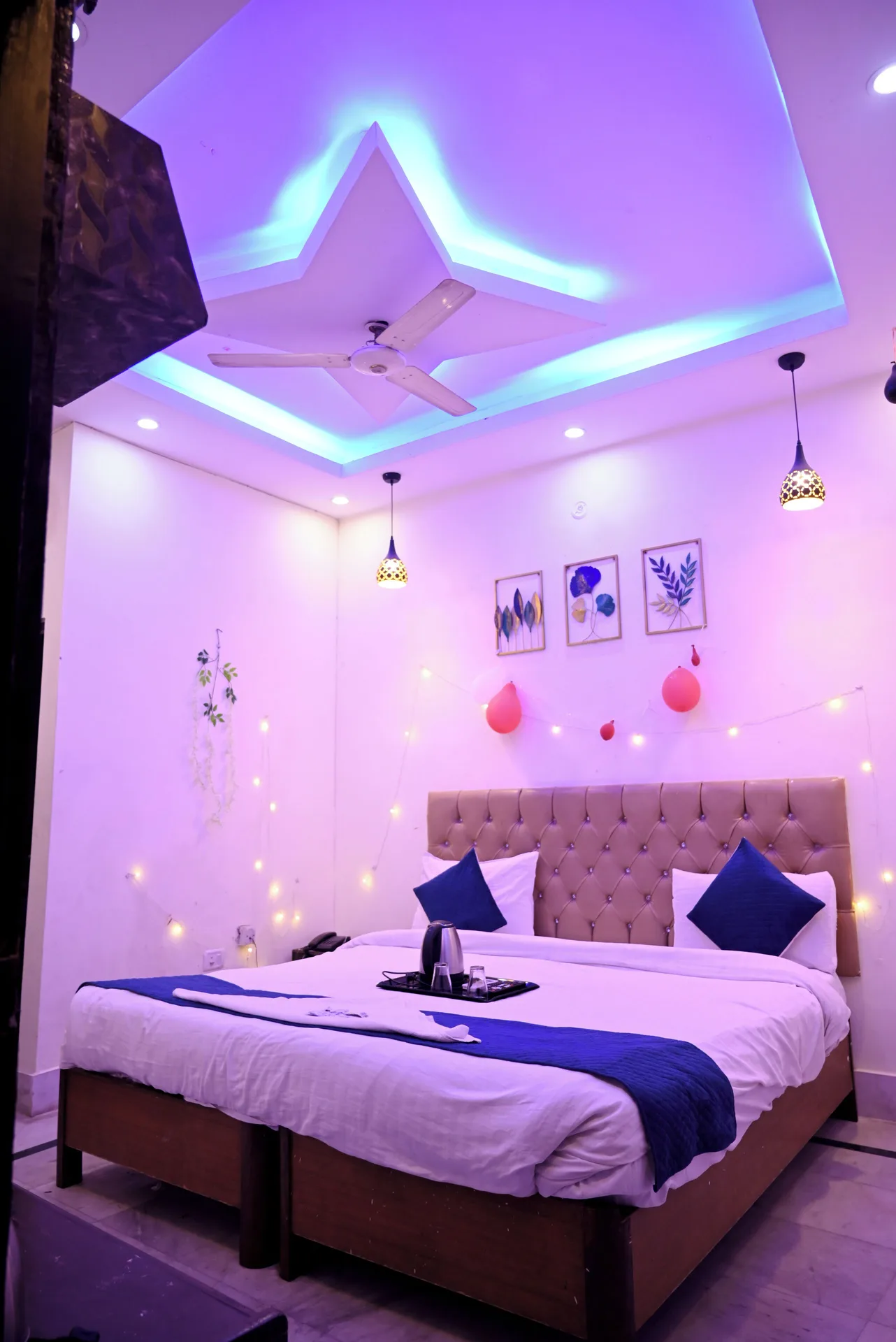 Premium Room king bed with blue accents and colored ceiling lights at Moon Palace.