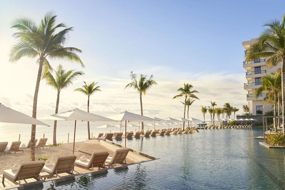 Waldorf Astoria Riviera Maya luxury beachfront resort with elegant suites, dining, and Caribbean views