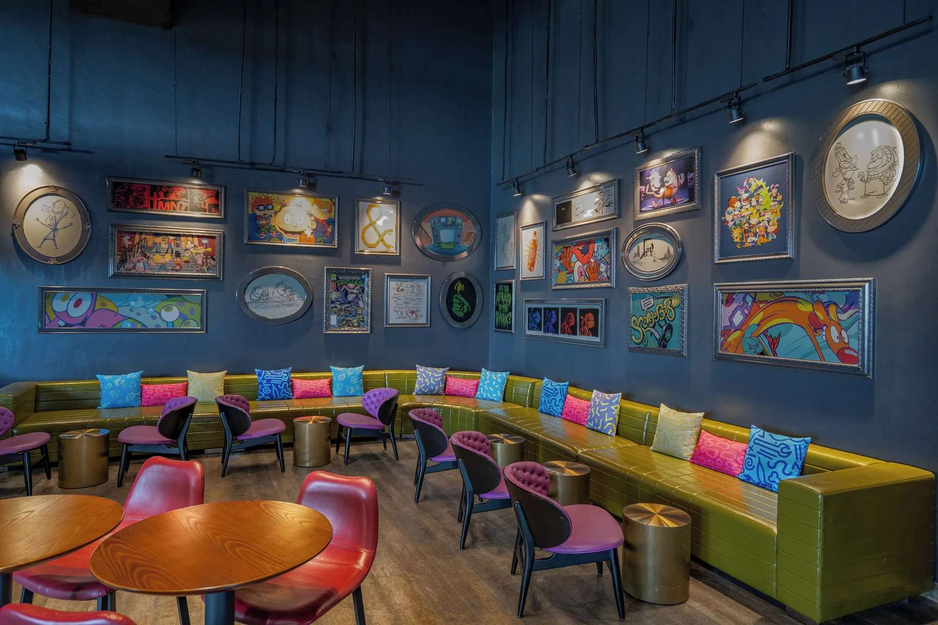 Lounge seating with framed cartoon artwork at Nickelodeon Hotels & Resorts Riviera Maya.