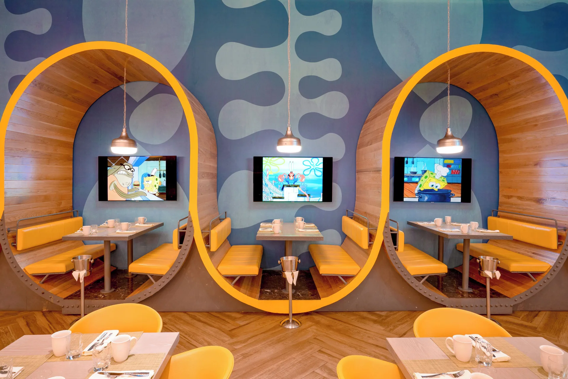 Le Spatula booths with round yellow frames at Nickelodeon Hotels & Resorts Riviera Maya.