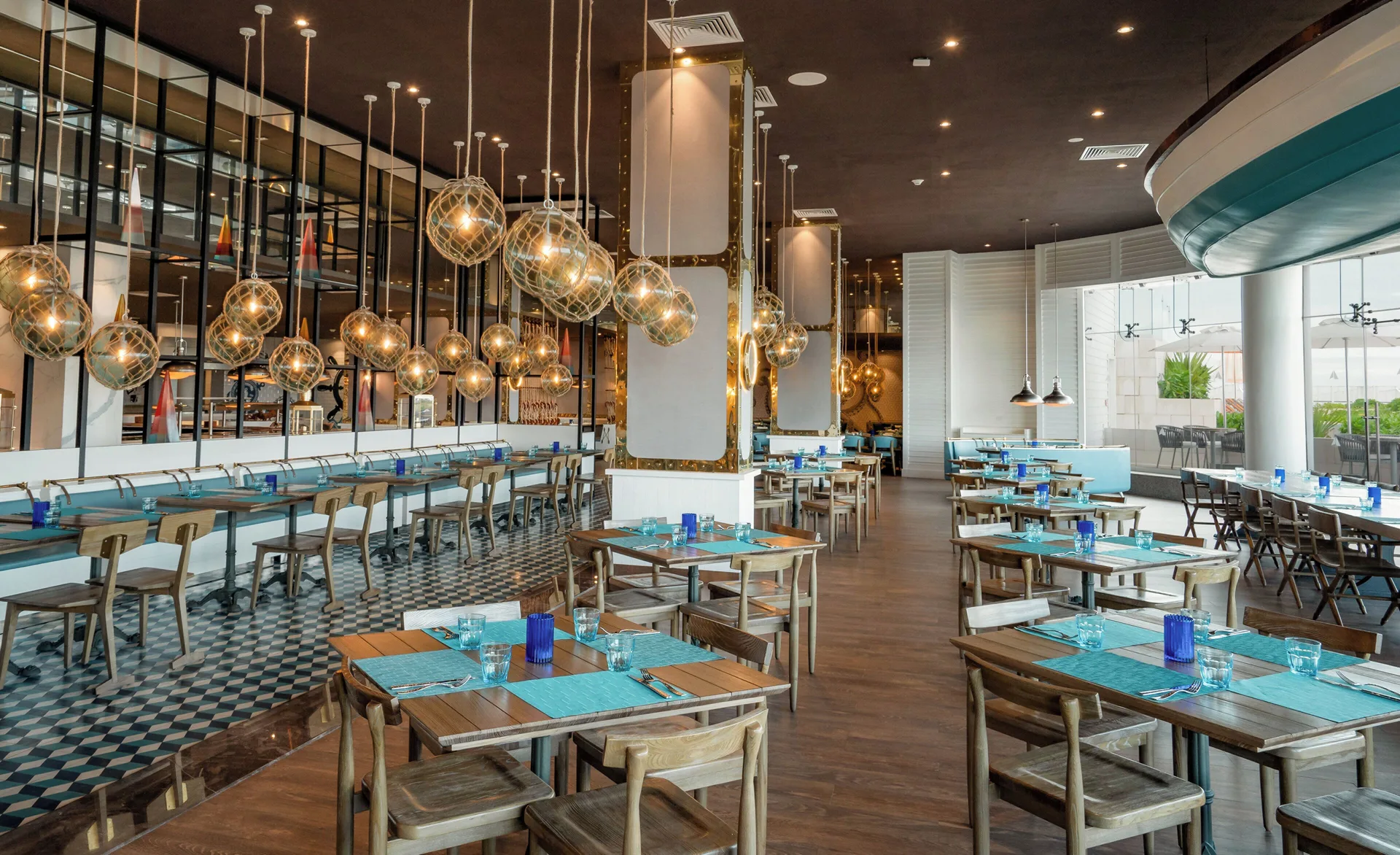 Bright restaurant dining room with nautical lights at Nickelodeon Hotels & Resorts Riviera Maya.