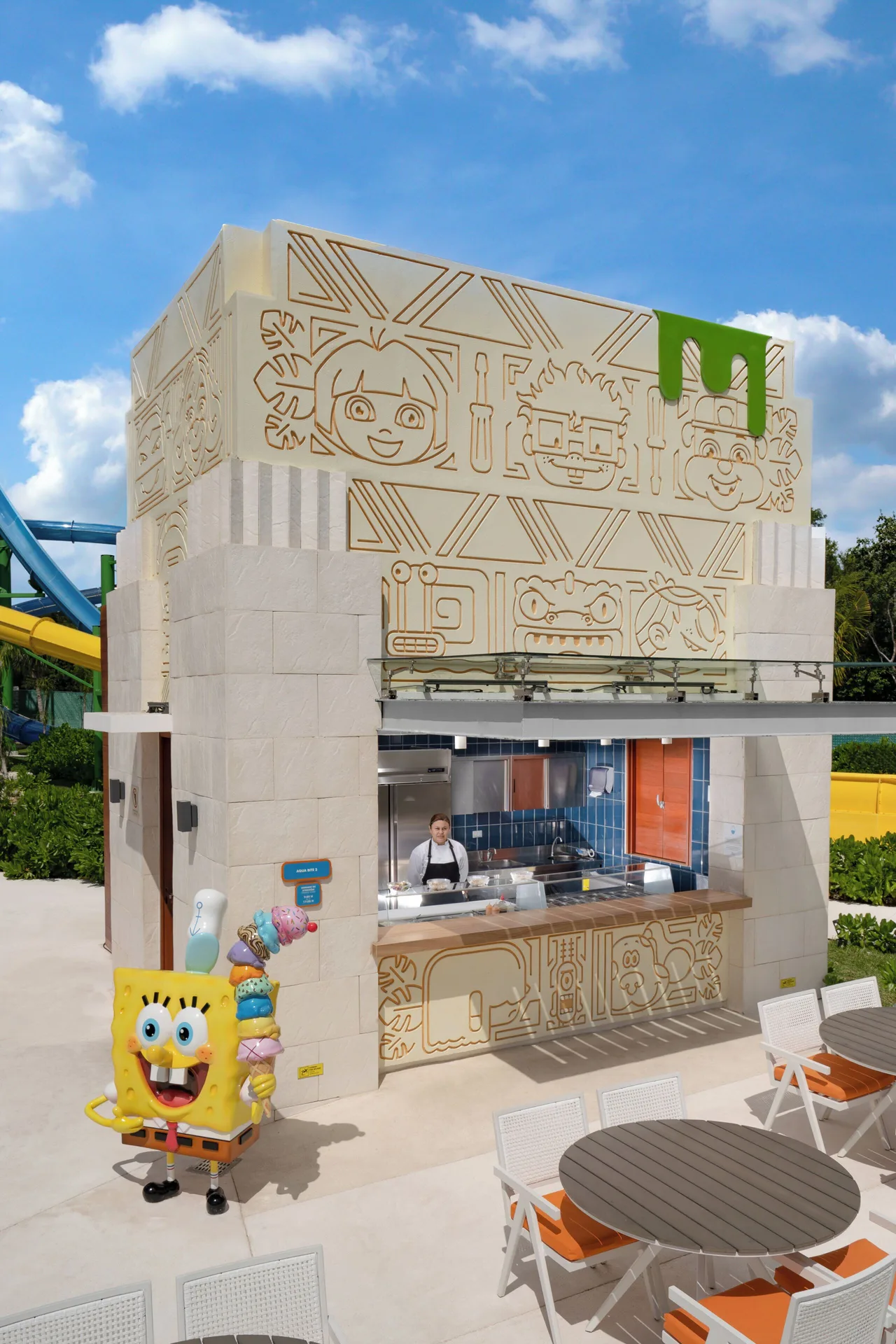Poolside snack counter with outdoor tables at Nickelodeon Hotels & Resorts Riviera Maya.