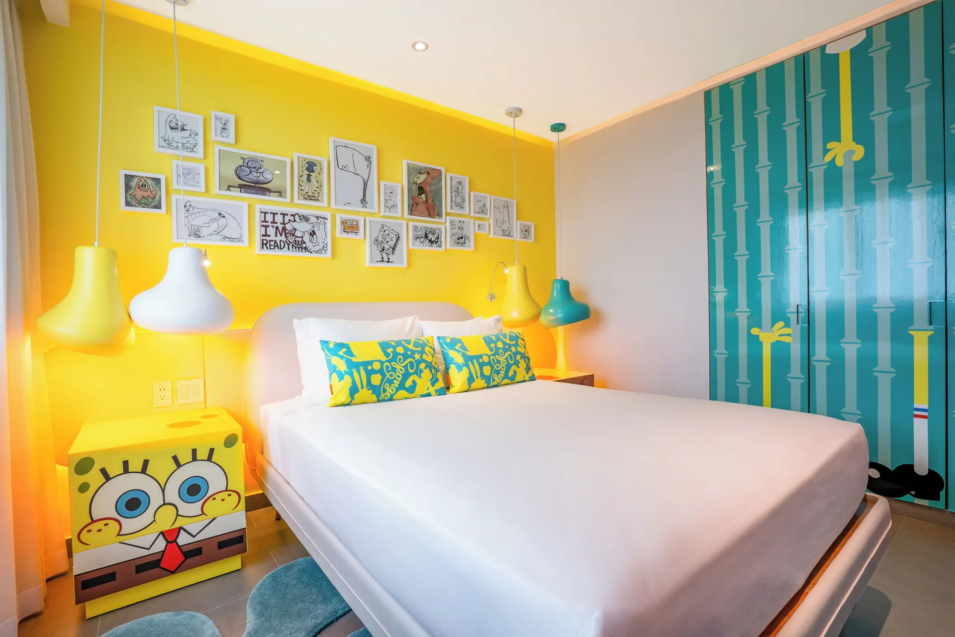 Pineapple Suite bedroom with white bed and SpongeBob decor at Nickelodeon Hotels & Resorts Riviera Maya.