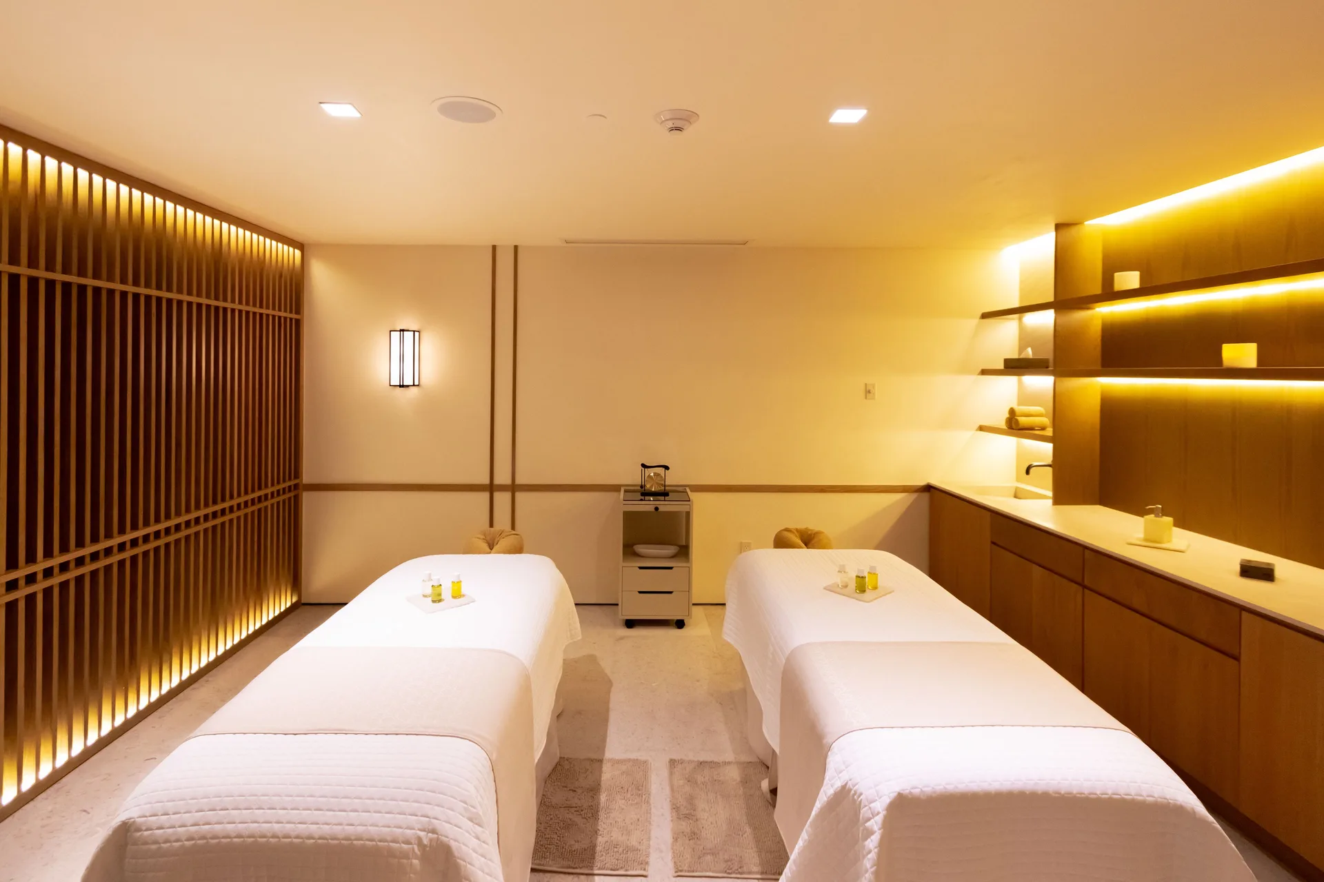 A spa treatment room with two massage tables at Nobu Hotel Los Cabos.