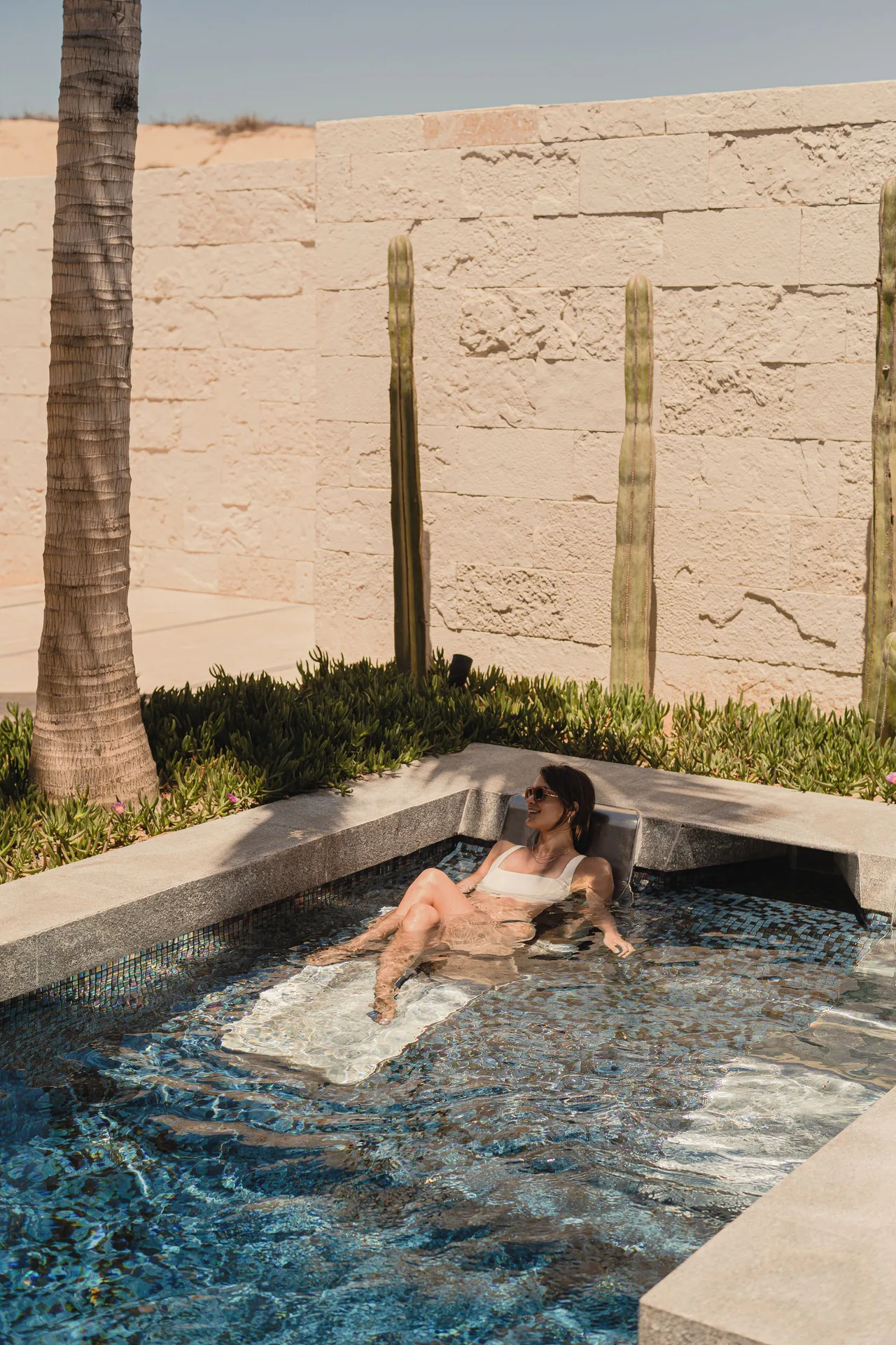 A guest relaxes in a small outdoor spa pool at Nobu Hotel Los Cabos.