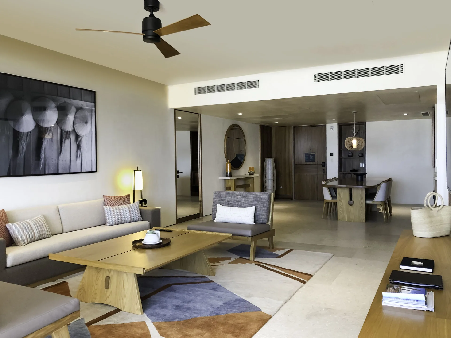 Suite living area with sofas, coffee table and dining space at Nobu Hotel Los Cabos.