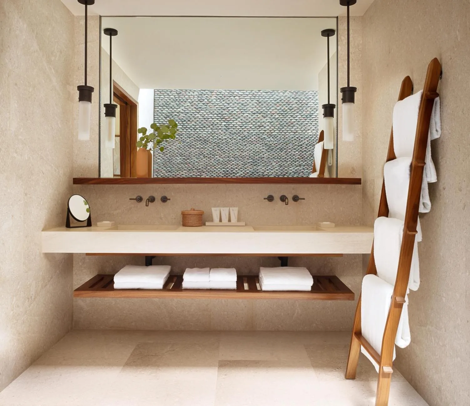 Deluxe bathroom vanity with mirror, pendant lights, and towel ladder at Nobu Hotel Los Cabos.