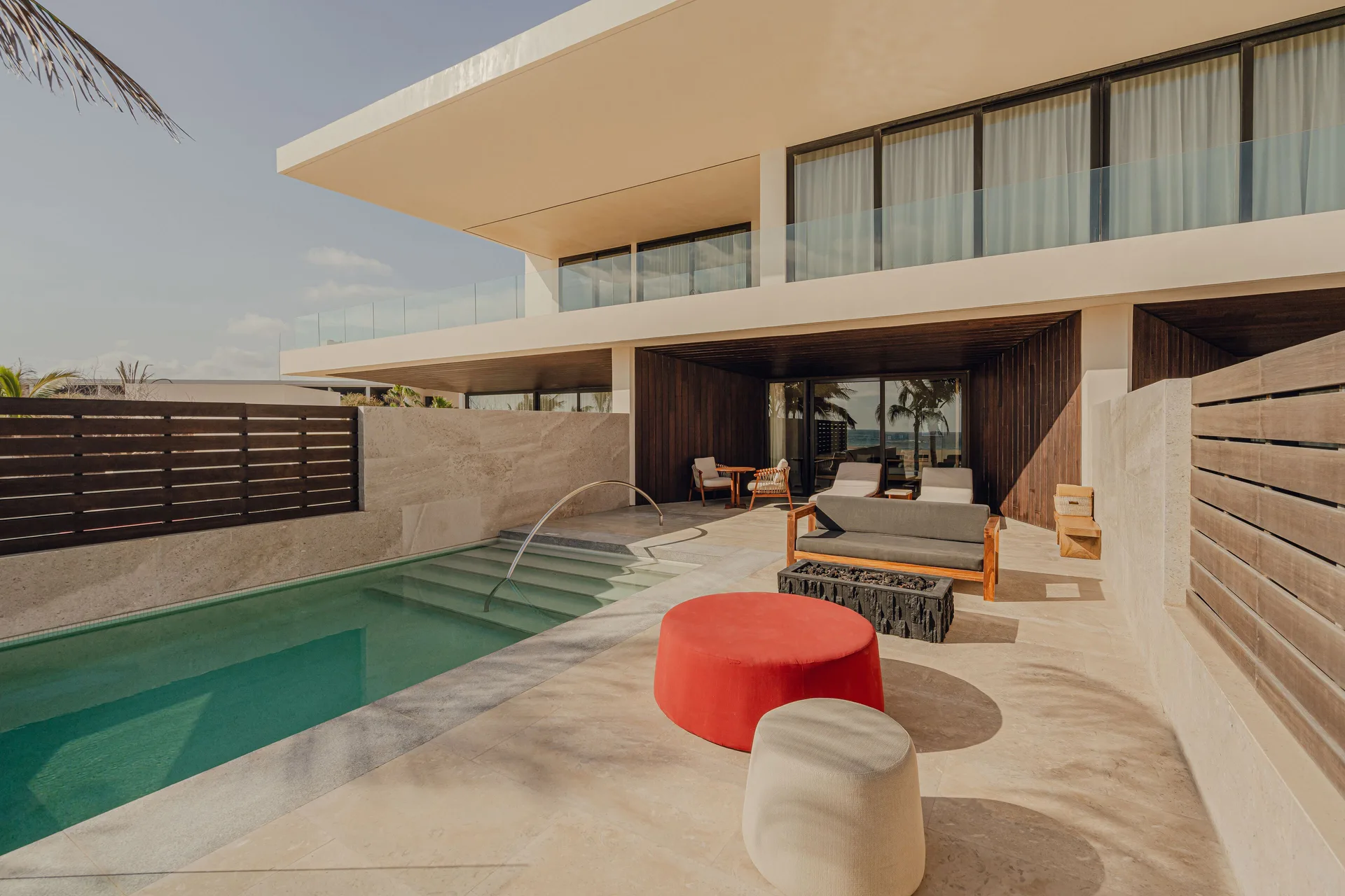 Private pool terrace of an oceanfront junior room at Nobu Hotel Los Cabos with loungers and seating.